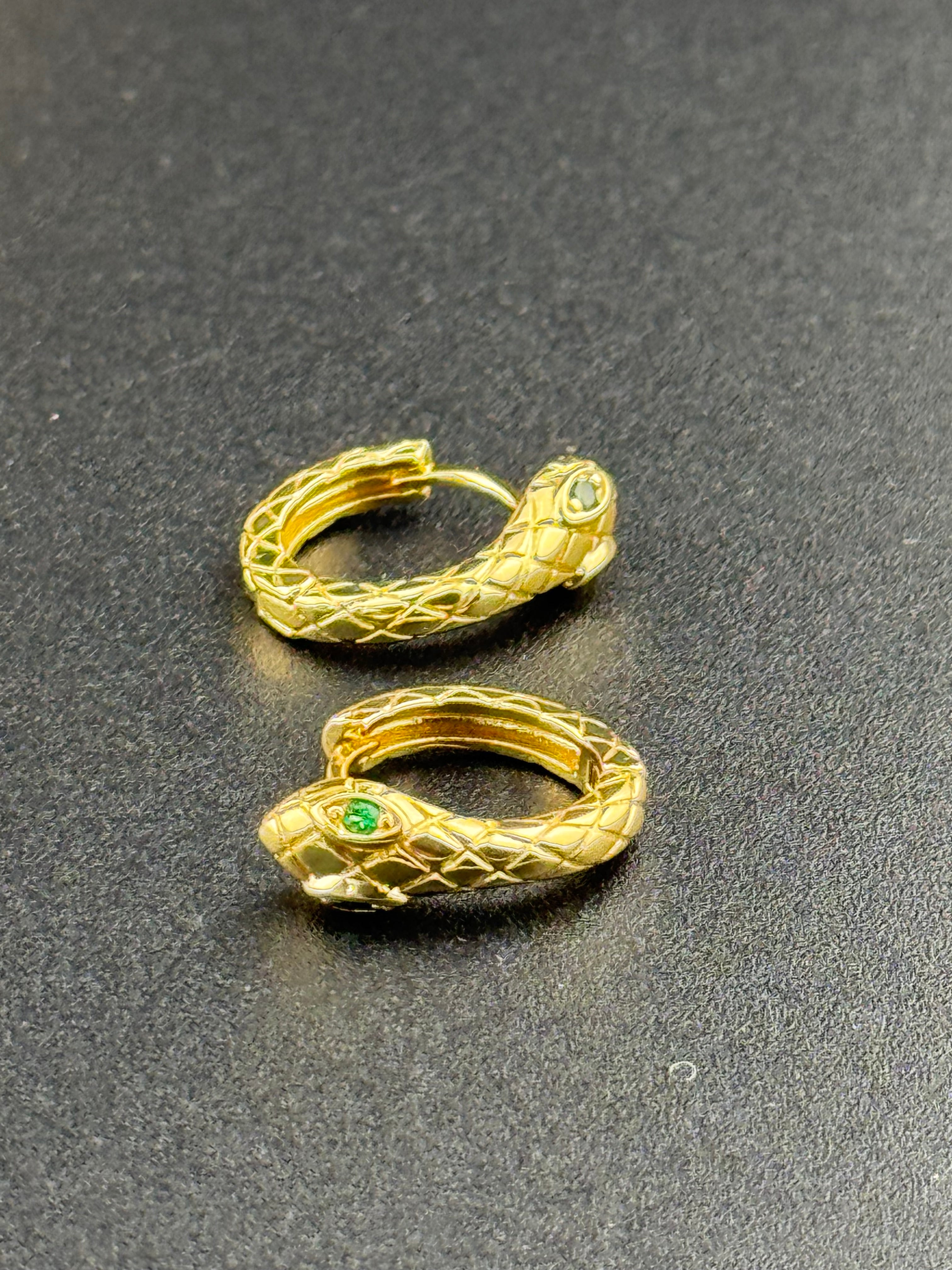 Small gold tone snake hoop earrings with CZ emerald eyes