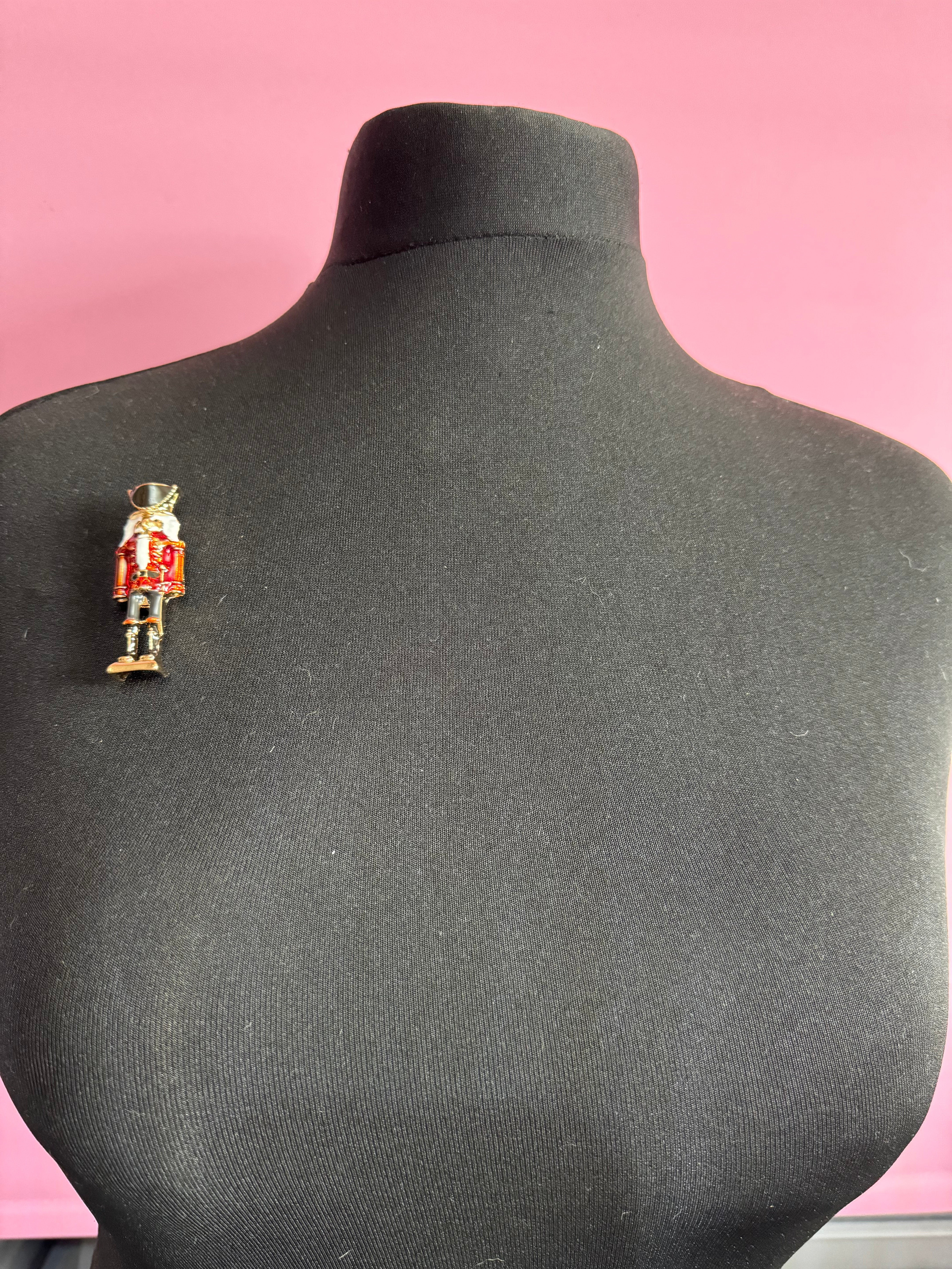 Nutcracker man soldier red and black enamel Christmas brooch