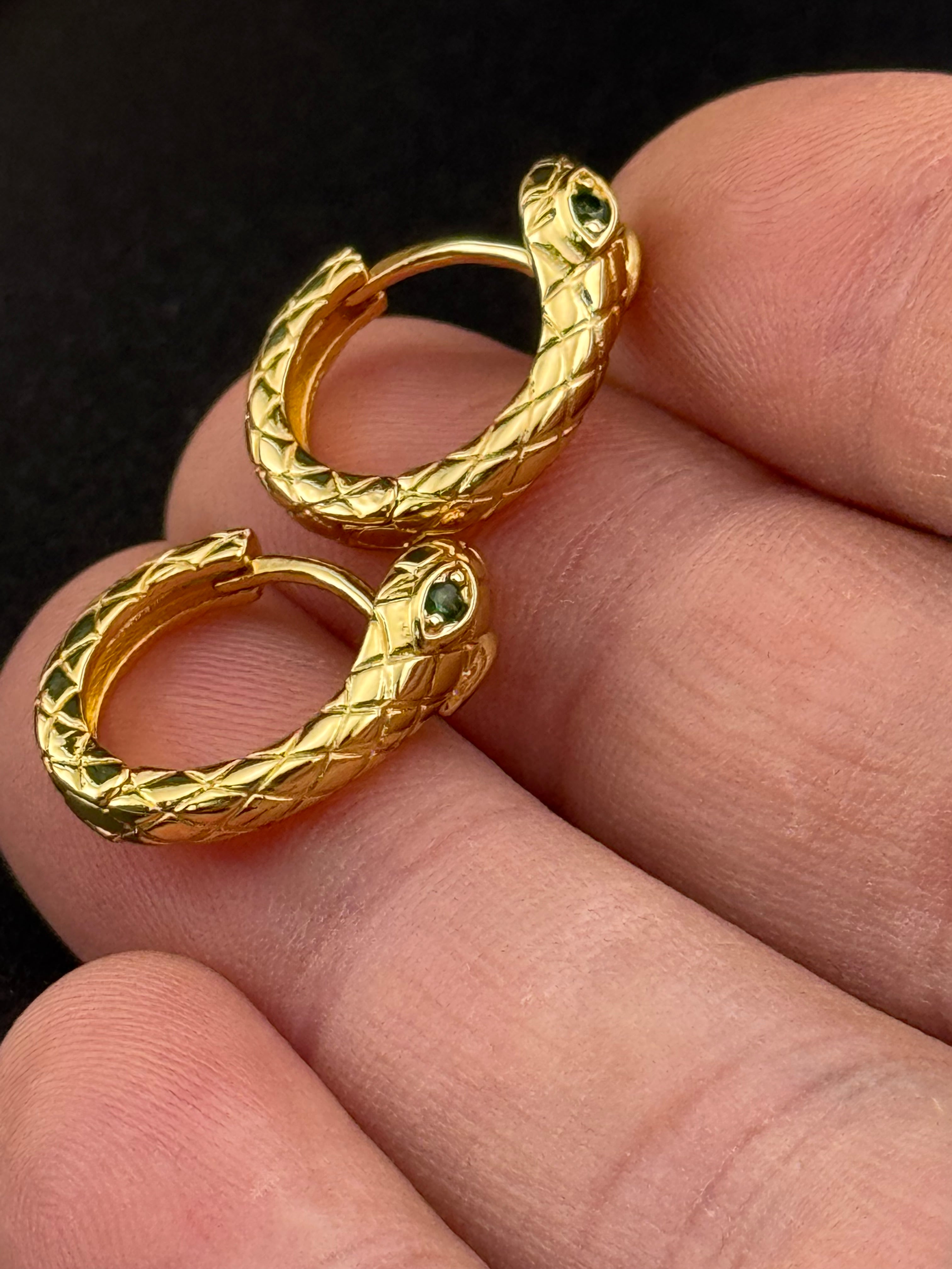 Small gold tone snake hoop earrings with CZ emerald eyes