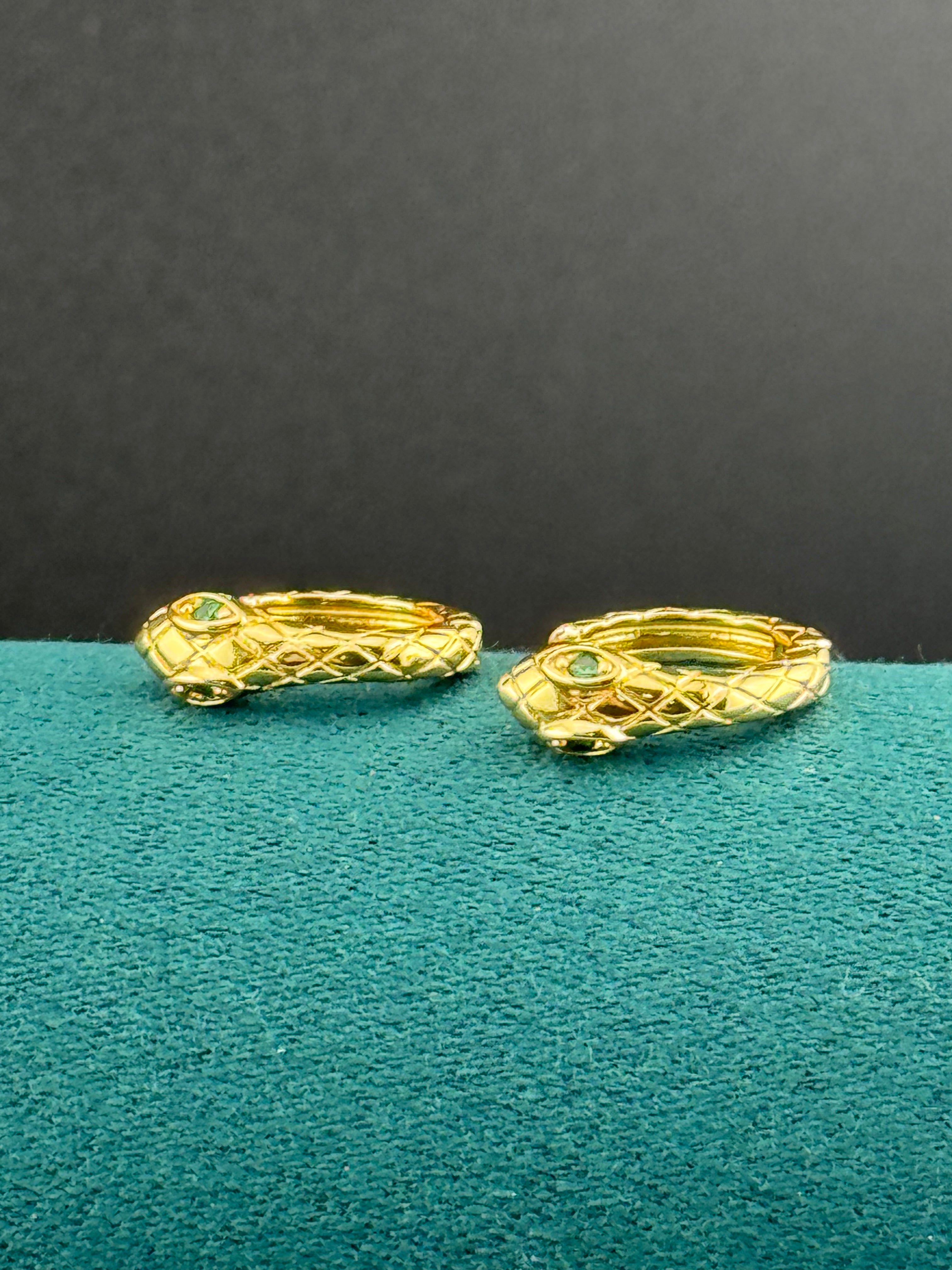 Small gold tone snake hoop earrings with CZ emerald eyes