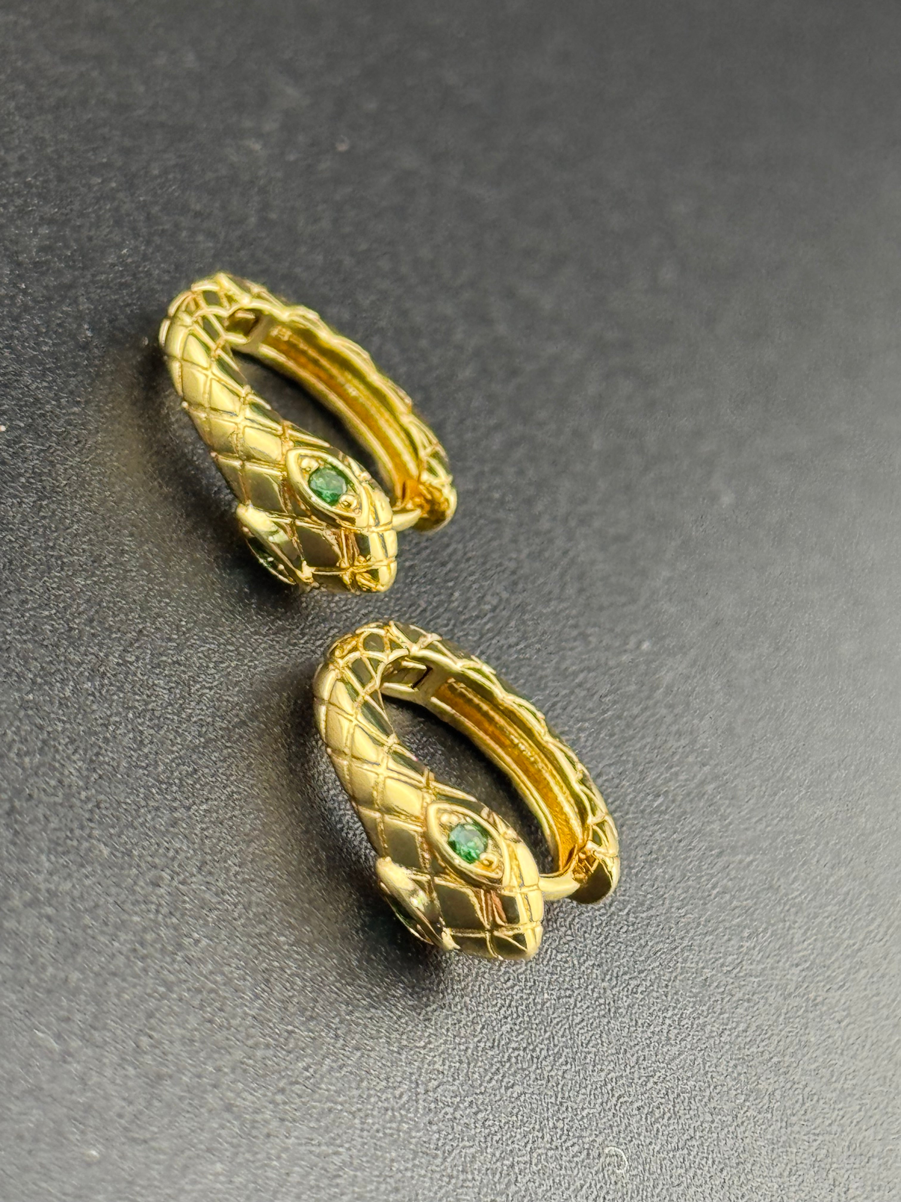 Small gold tone snake hoop earrings with CZ emerald eyes