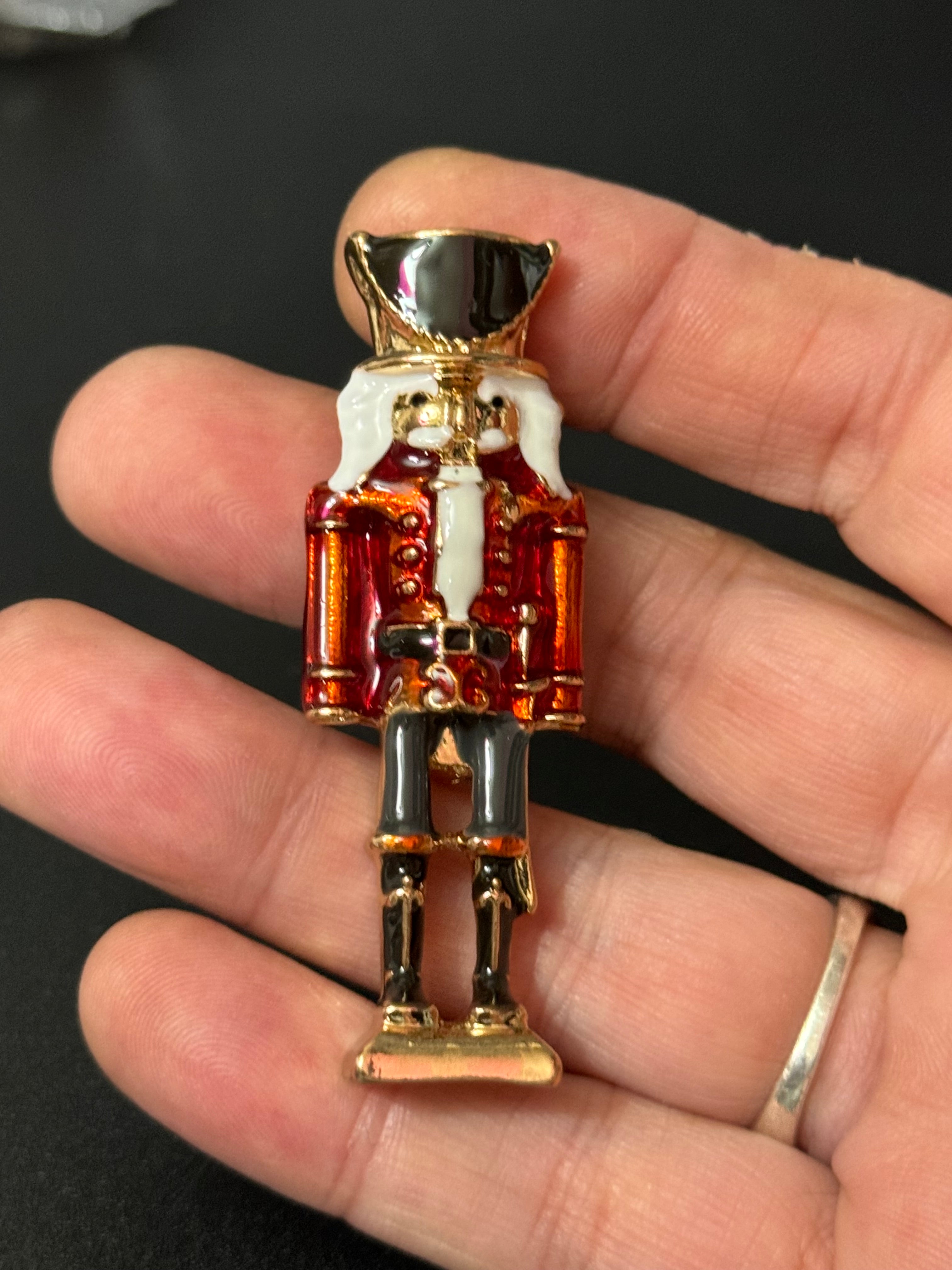 Nutcracker man soldier red and black enamel Christmas brooch