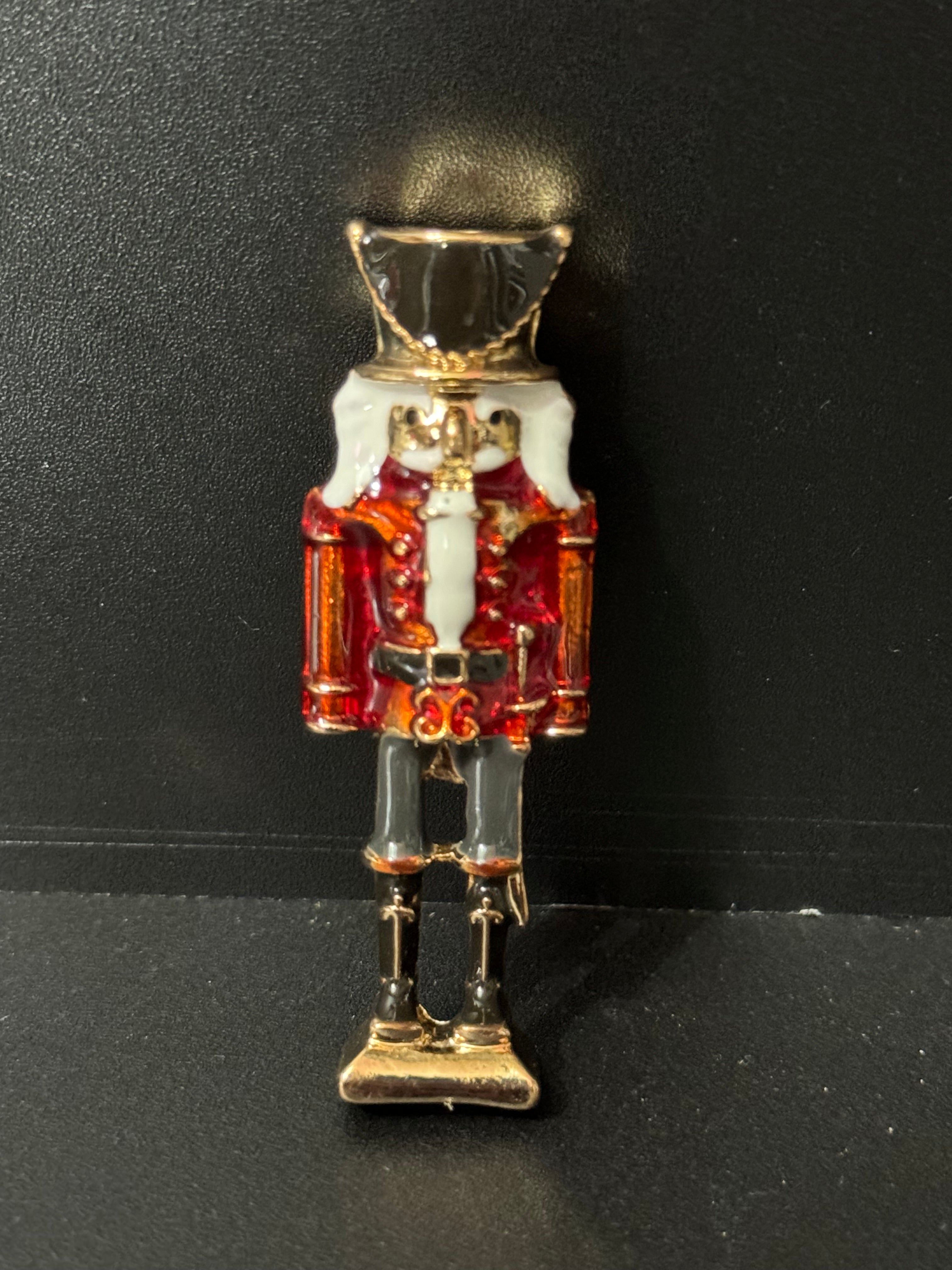 Nutcracker man soldier red and black enamel Christmas brooch