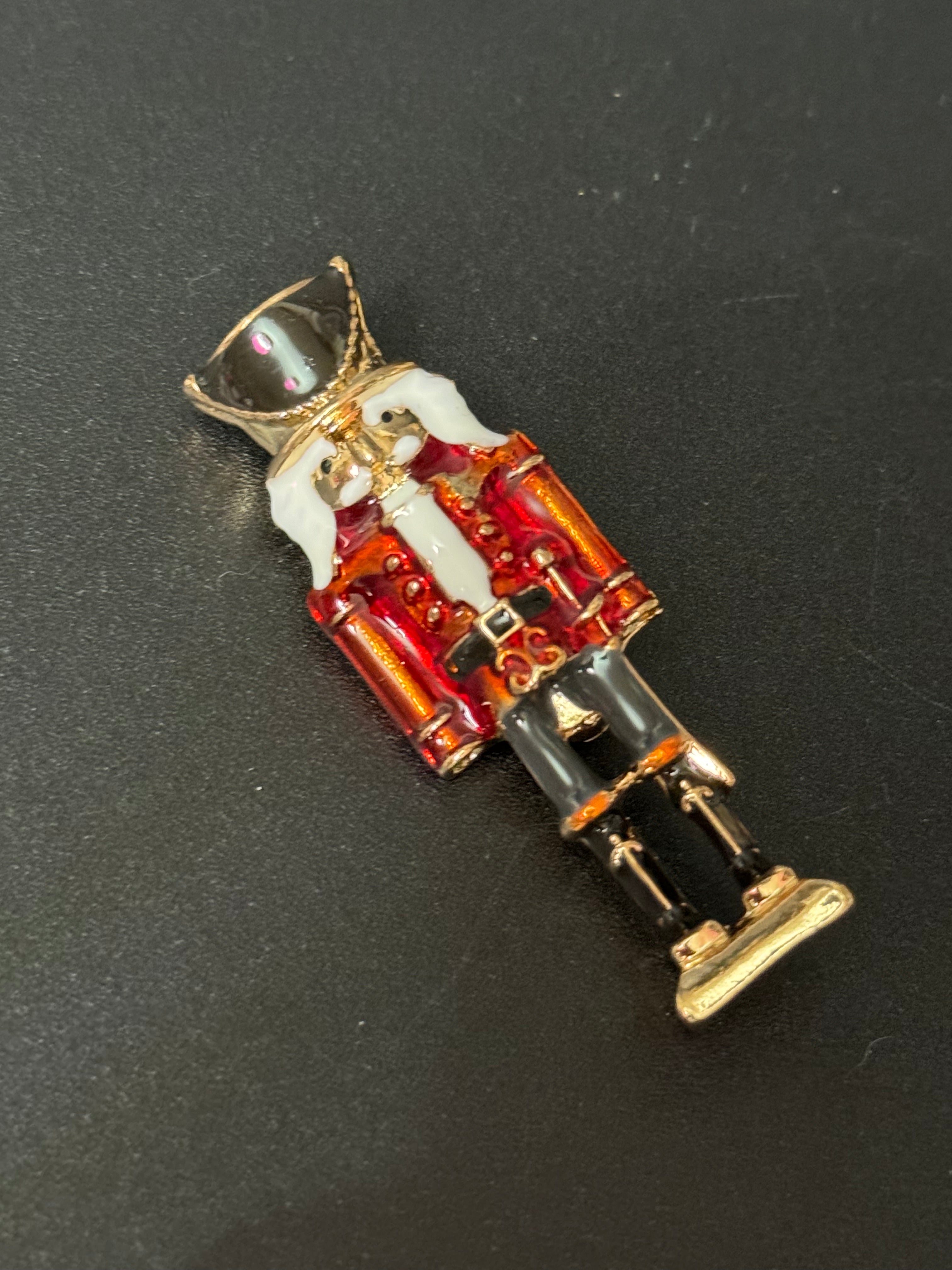 Nutcracker man soldier red and black enamel Christmas brooch