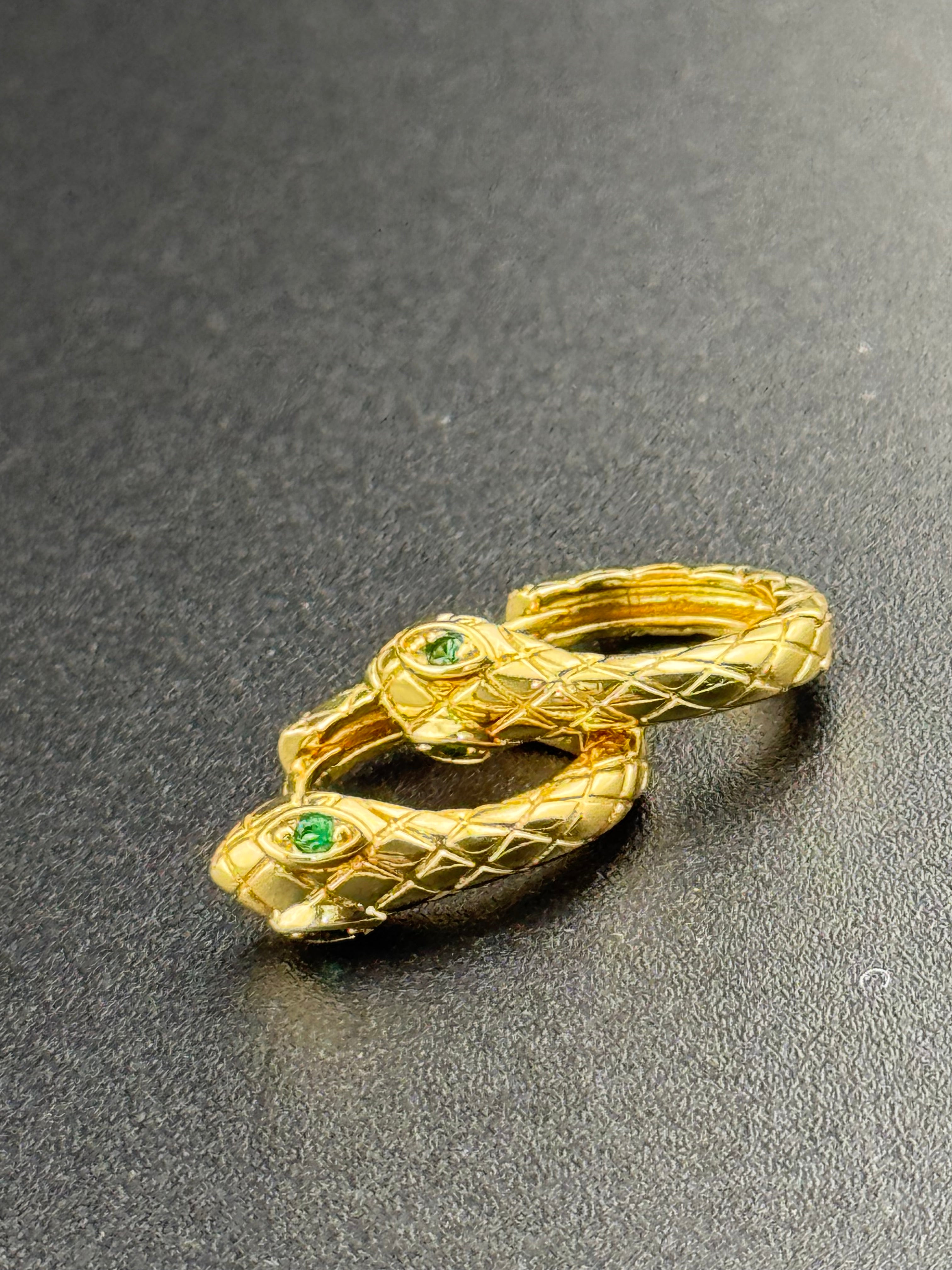 Small gold tone snake hoop earrings with CZ emerald eyes