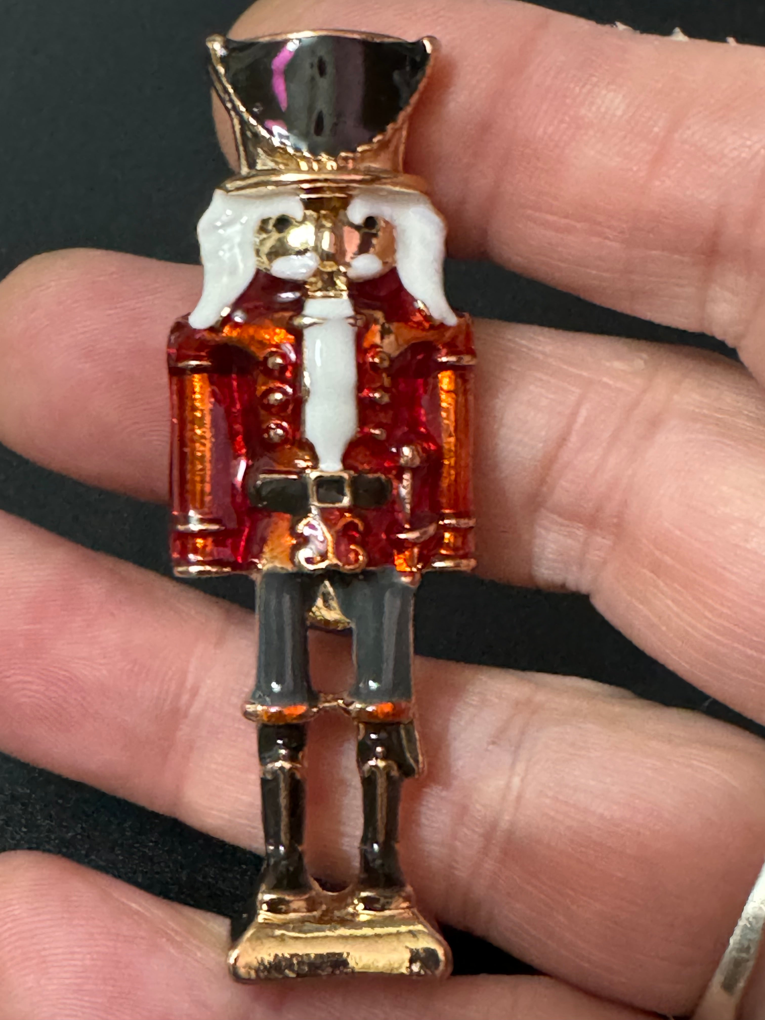 Nutcracker man soldier red and black enamel Christmas brooch