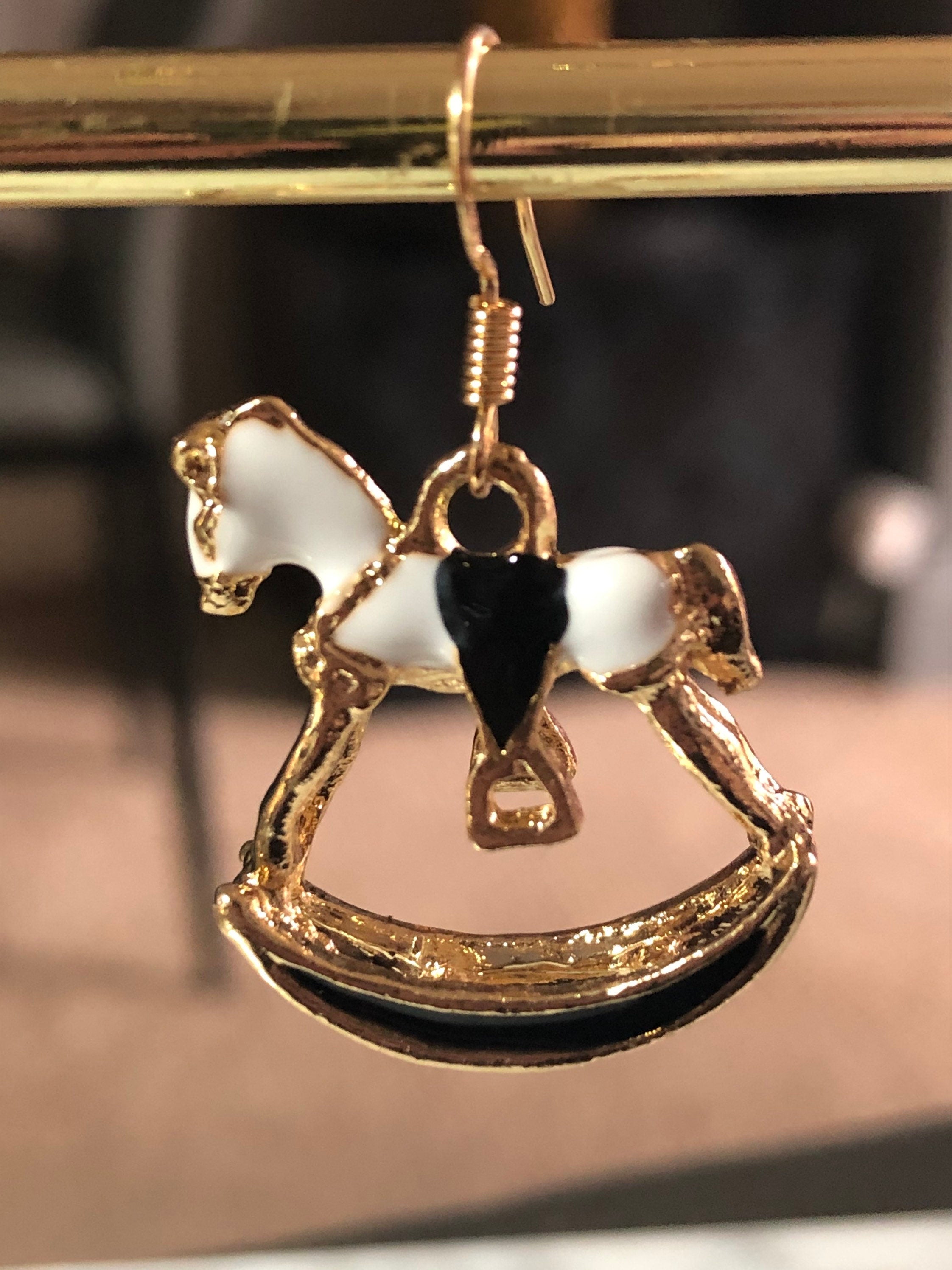 white & black enamel gold tone rocking horse earrings