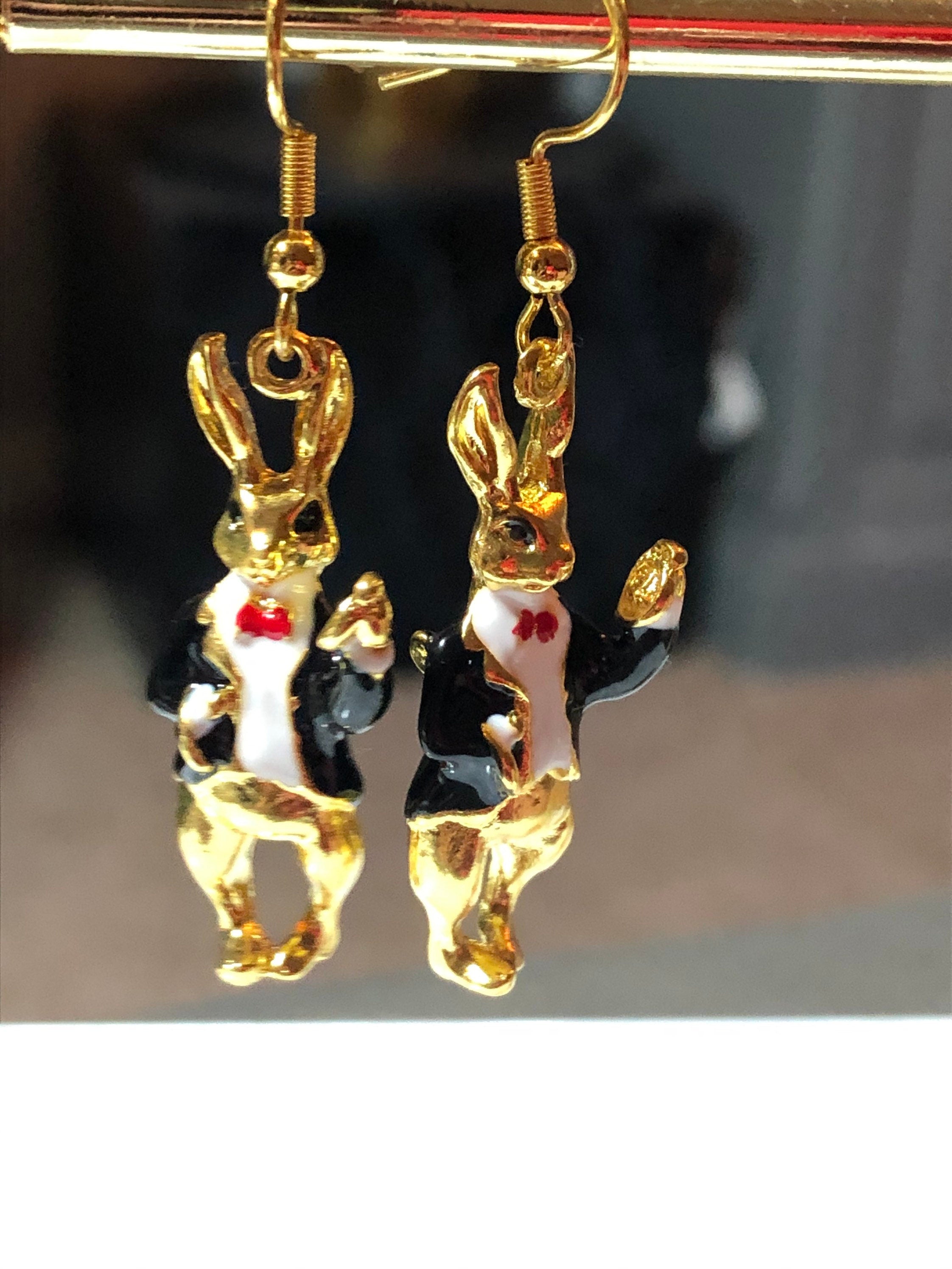 white & black enamel gold tone rocking horse earrings