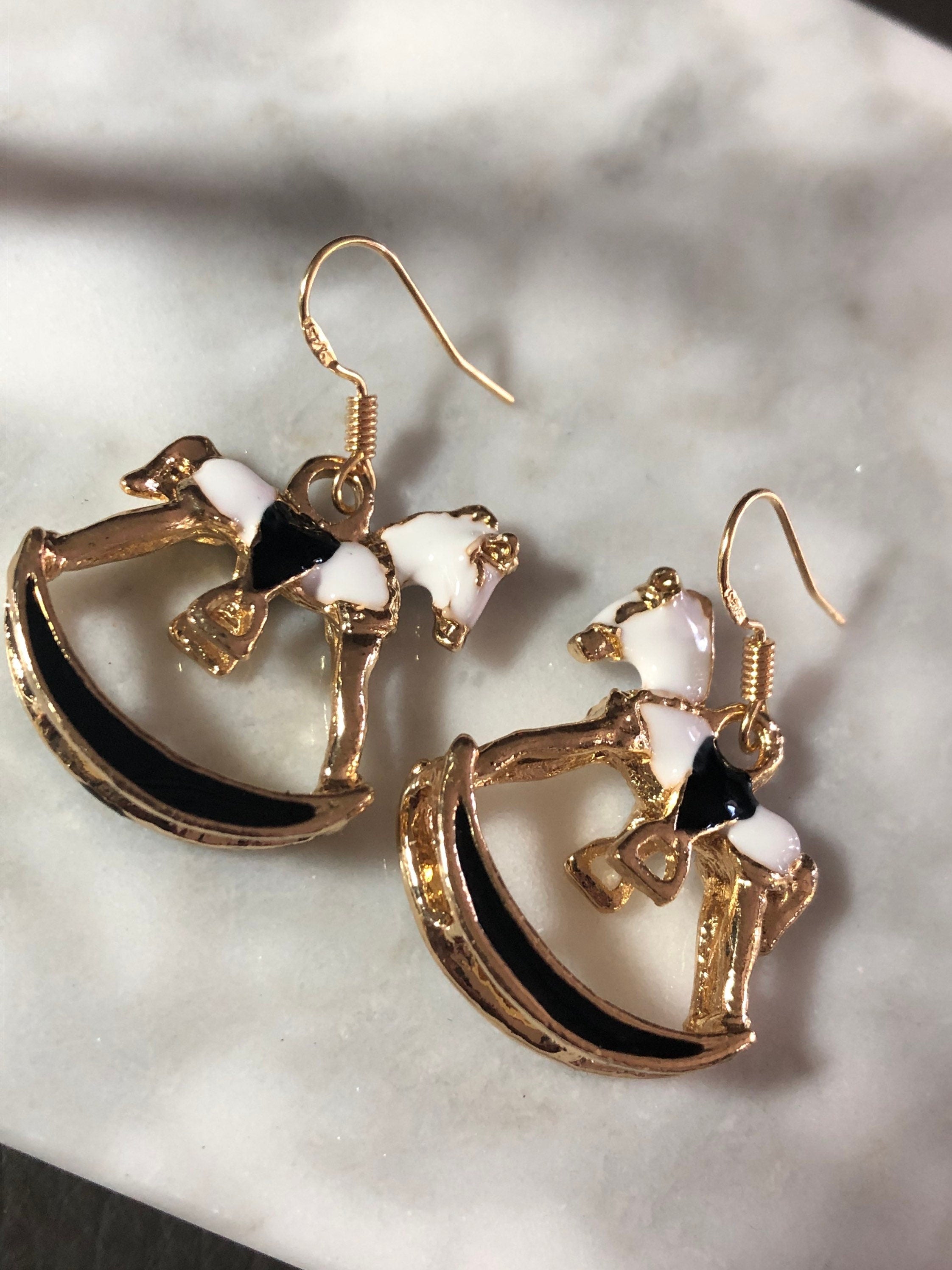 white & black enamel gold tone rocking horse earrings