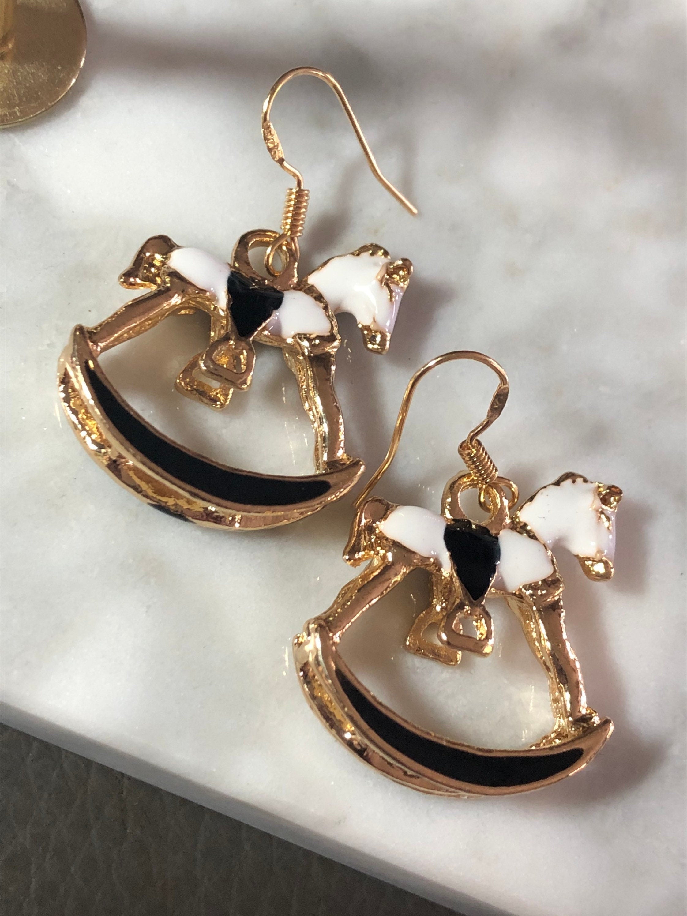 white & black enamel gold tone rocking horse earrings