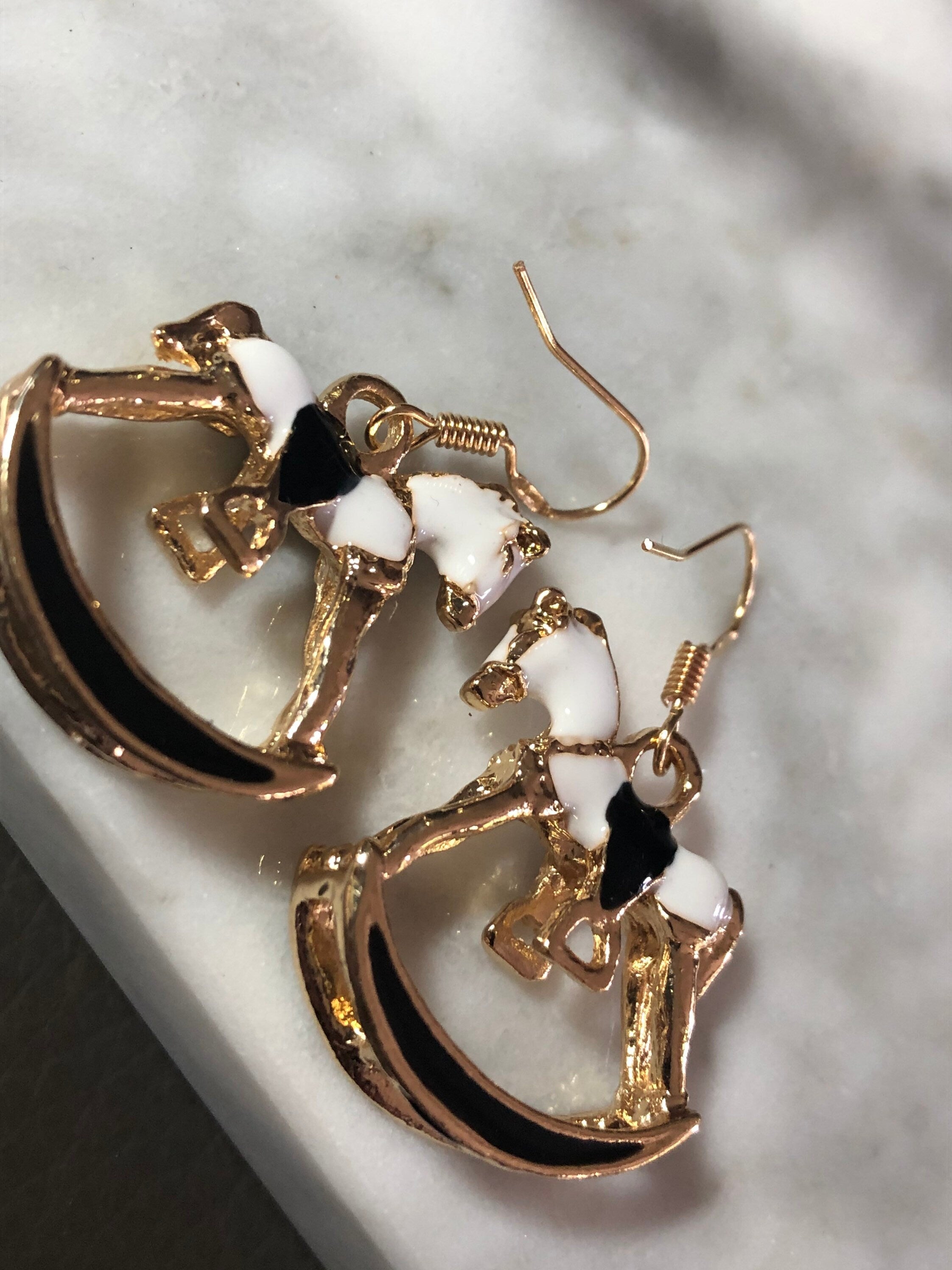 white & black enamel gold tone rocking horse earrings