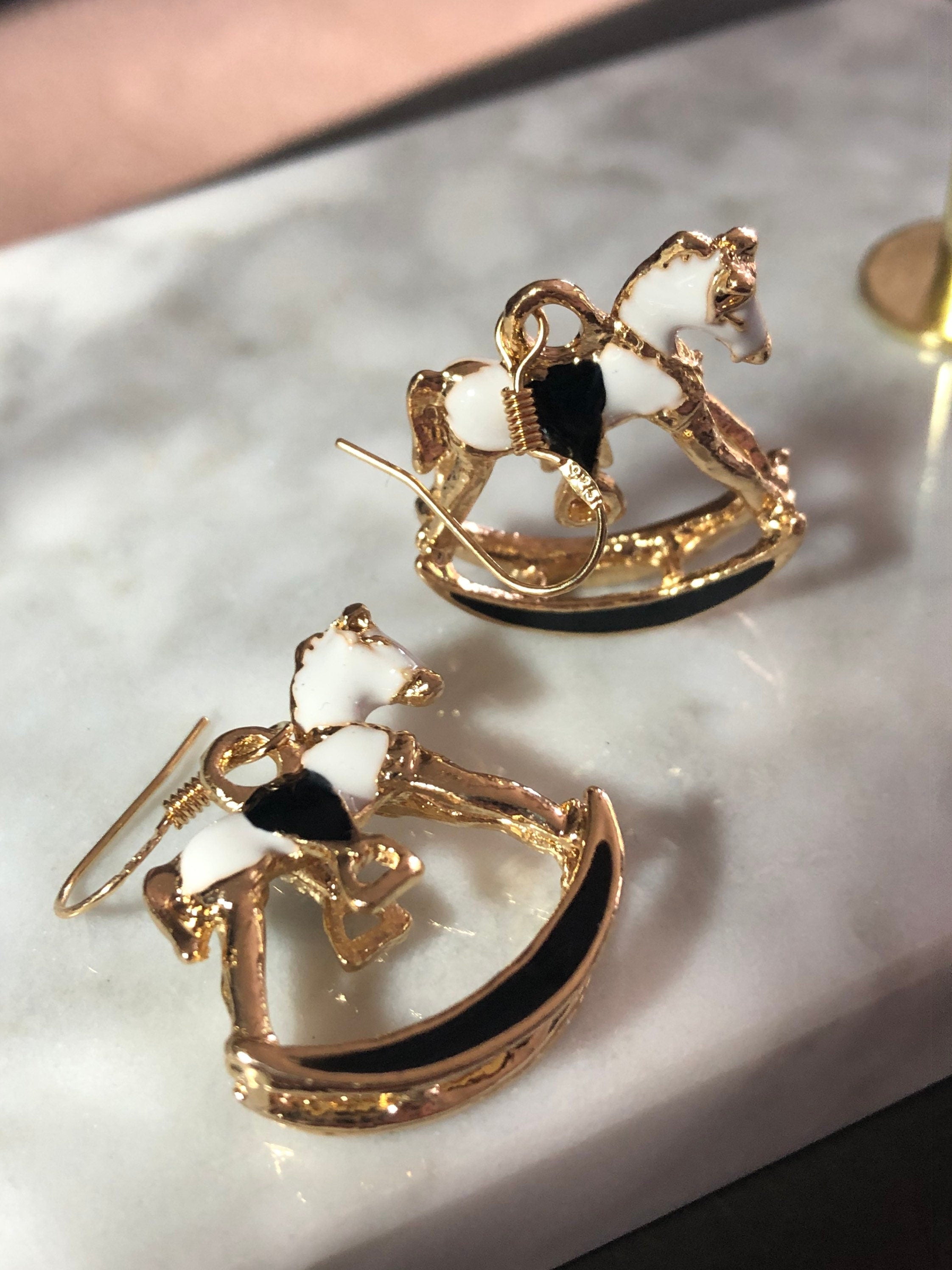 white & black enamel gold tone rocking horse earrings