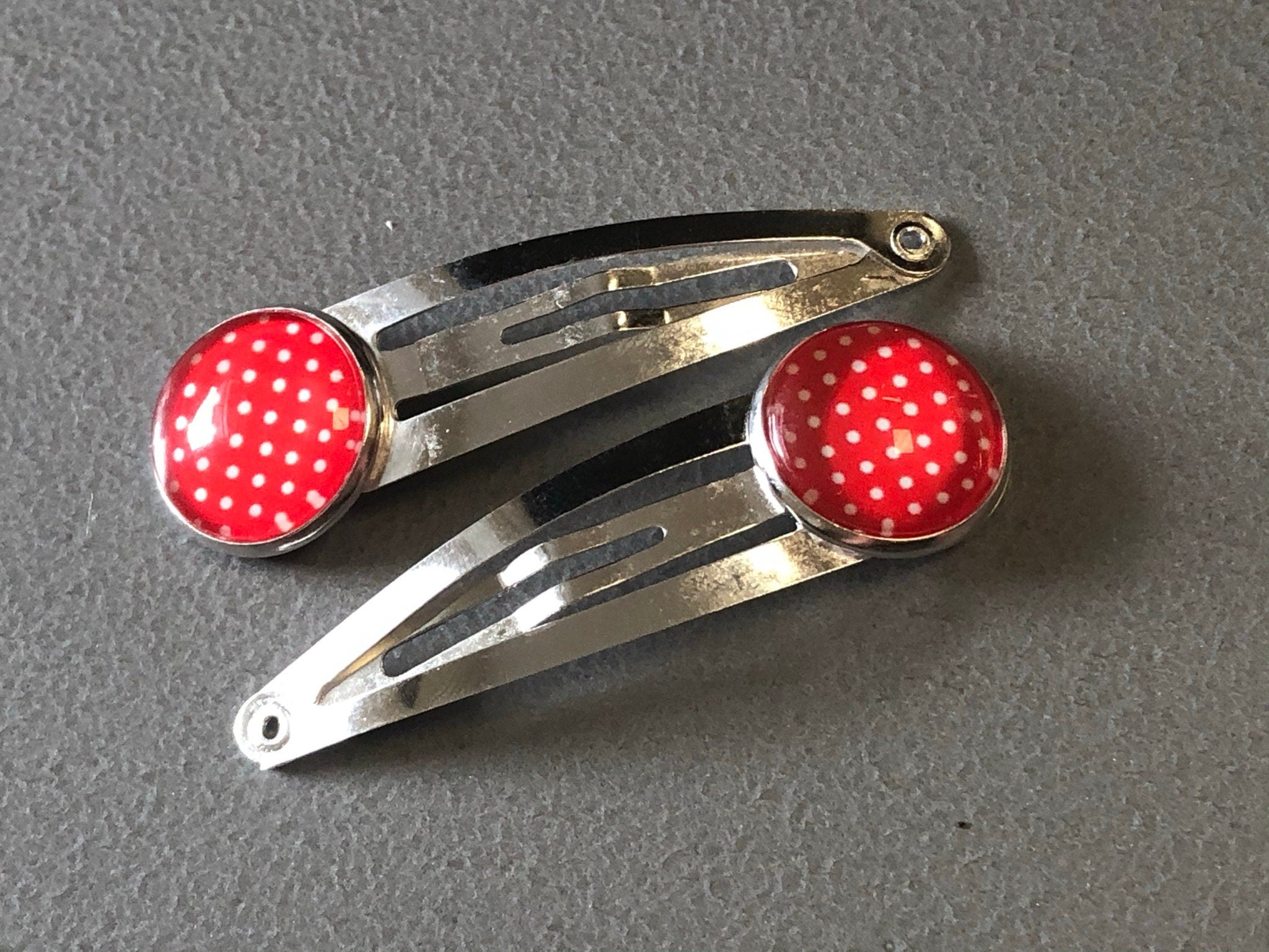 pair of red & white polka dot hair clips silver tone snap lock closure