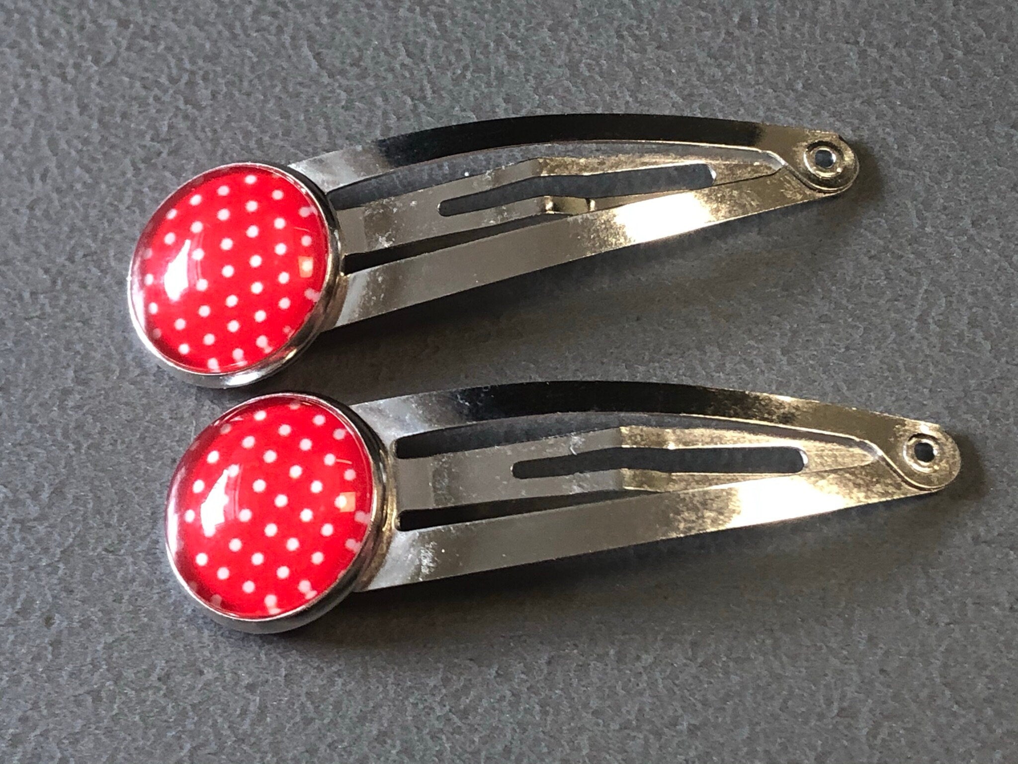 pair of red & white polka dot hair clips silver tone snap lock closure