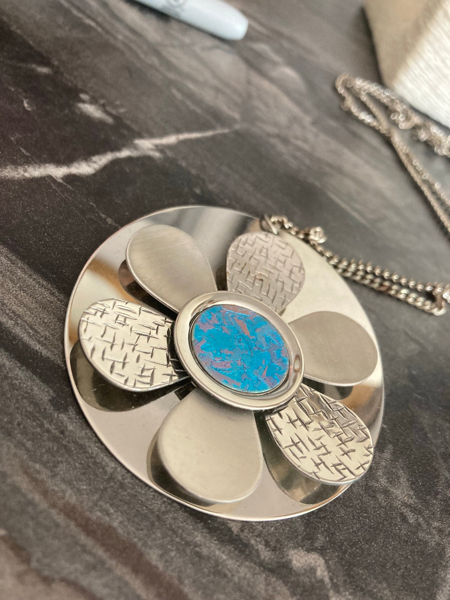 Huge modernist silver tone metal necklace with silver and blue stainless steel floral medallion pendant  BOHO hippie festival necklace