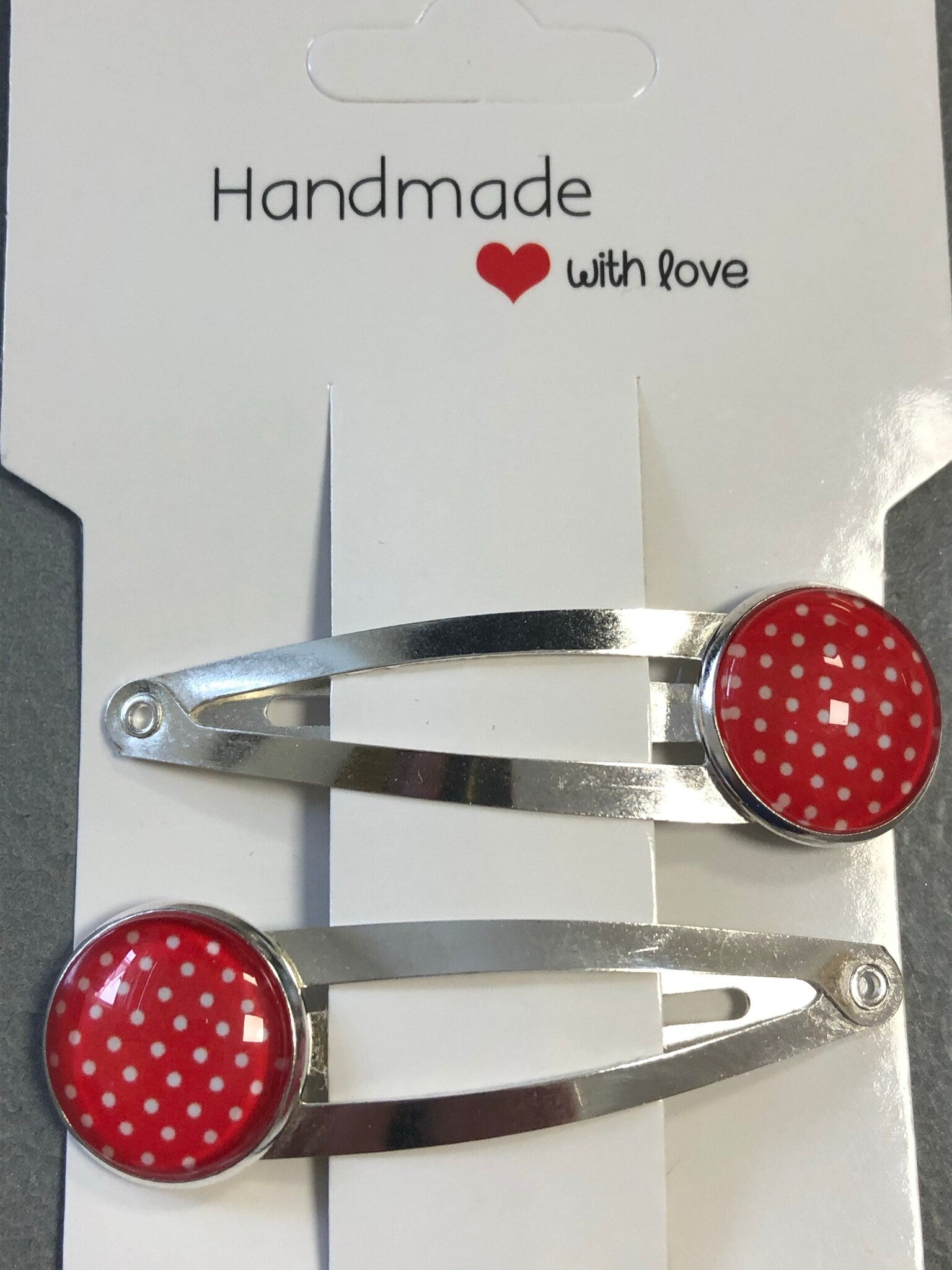 pair of red & white polka dot hair clips silver tone snap lock closure