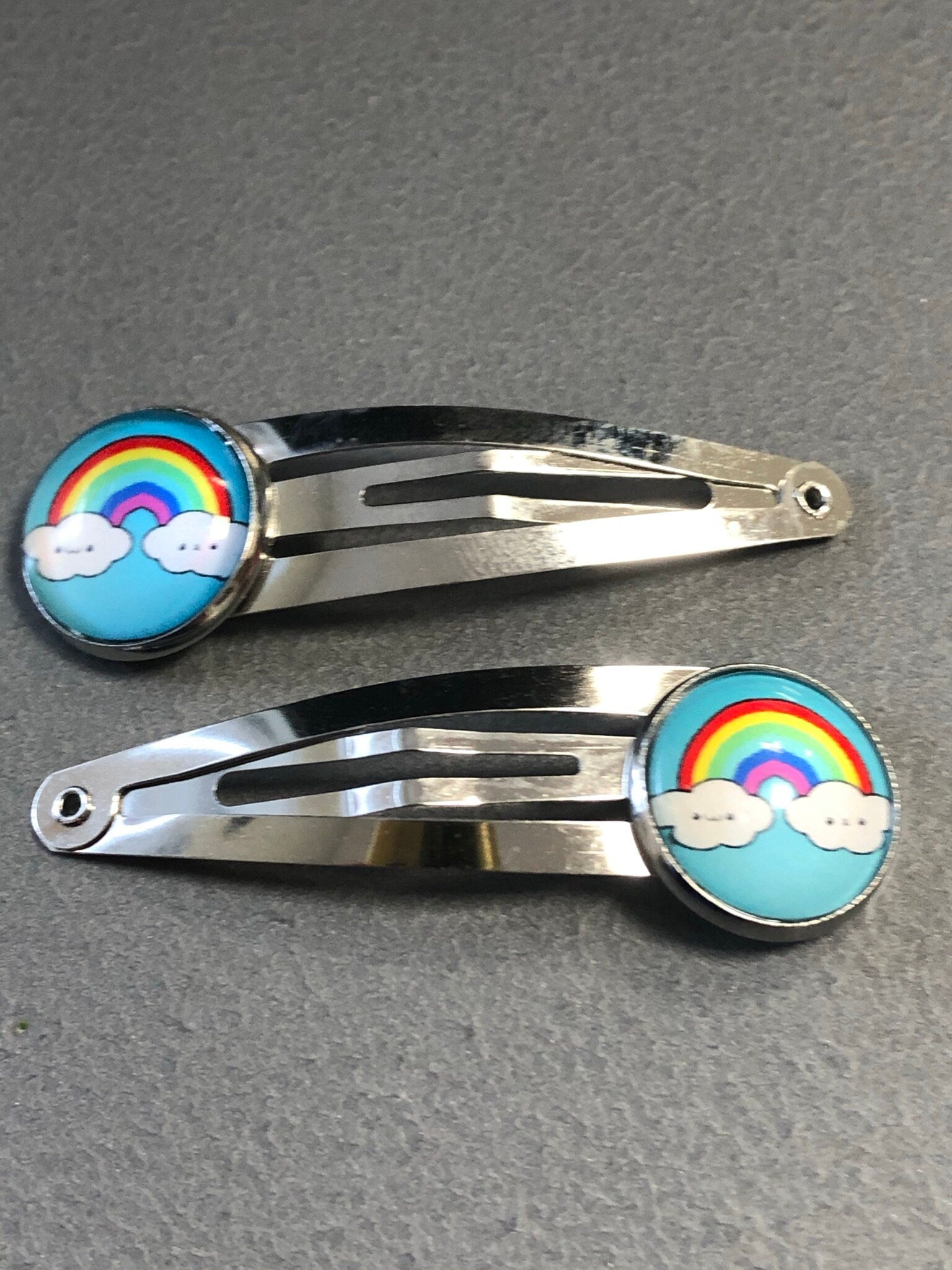 pair of girls rainbow hair clips silver tone snap lock closure