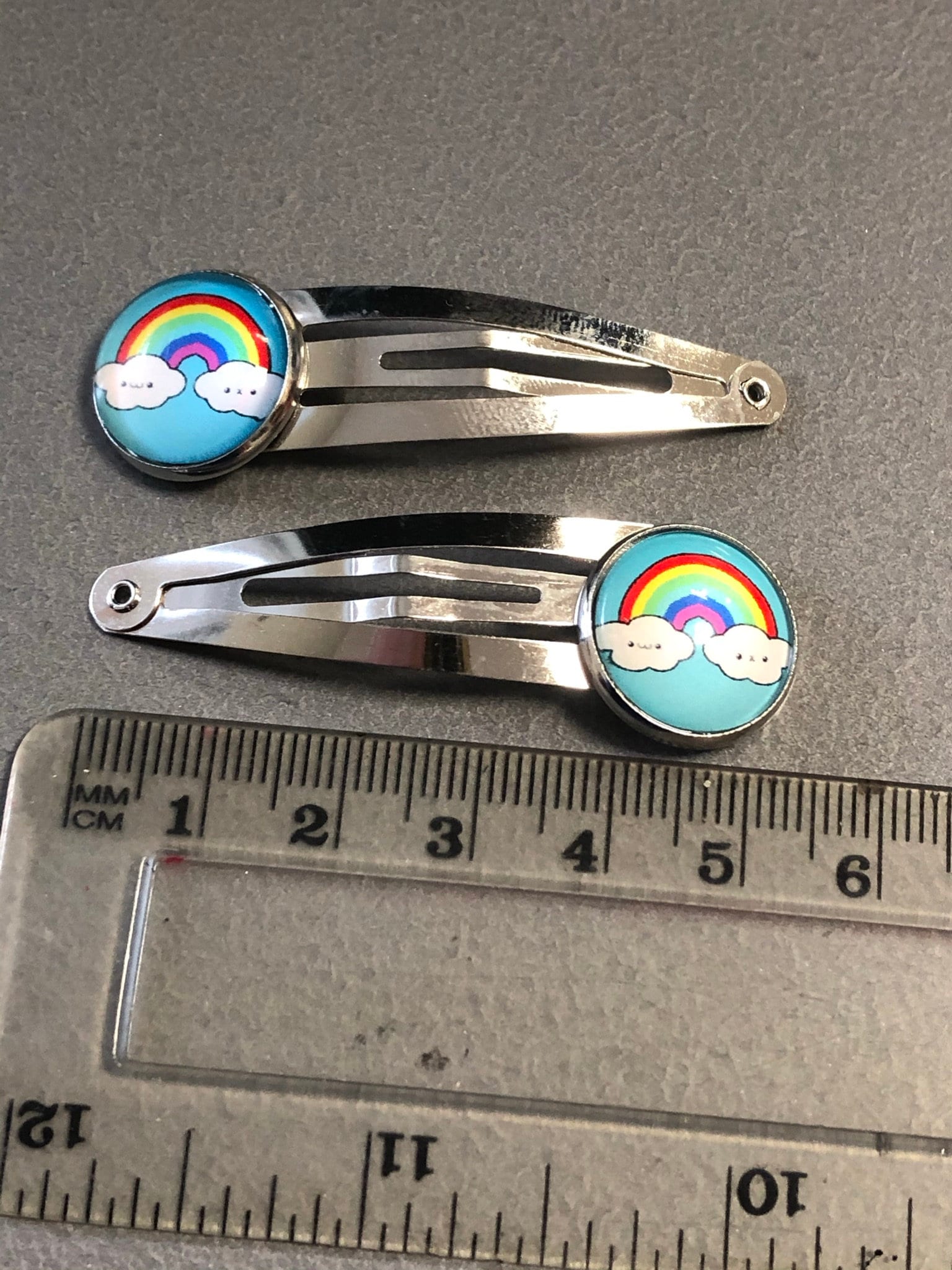 pair of girls rainbow hair clips silver tone snap lock closure