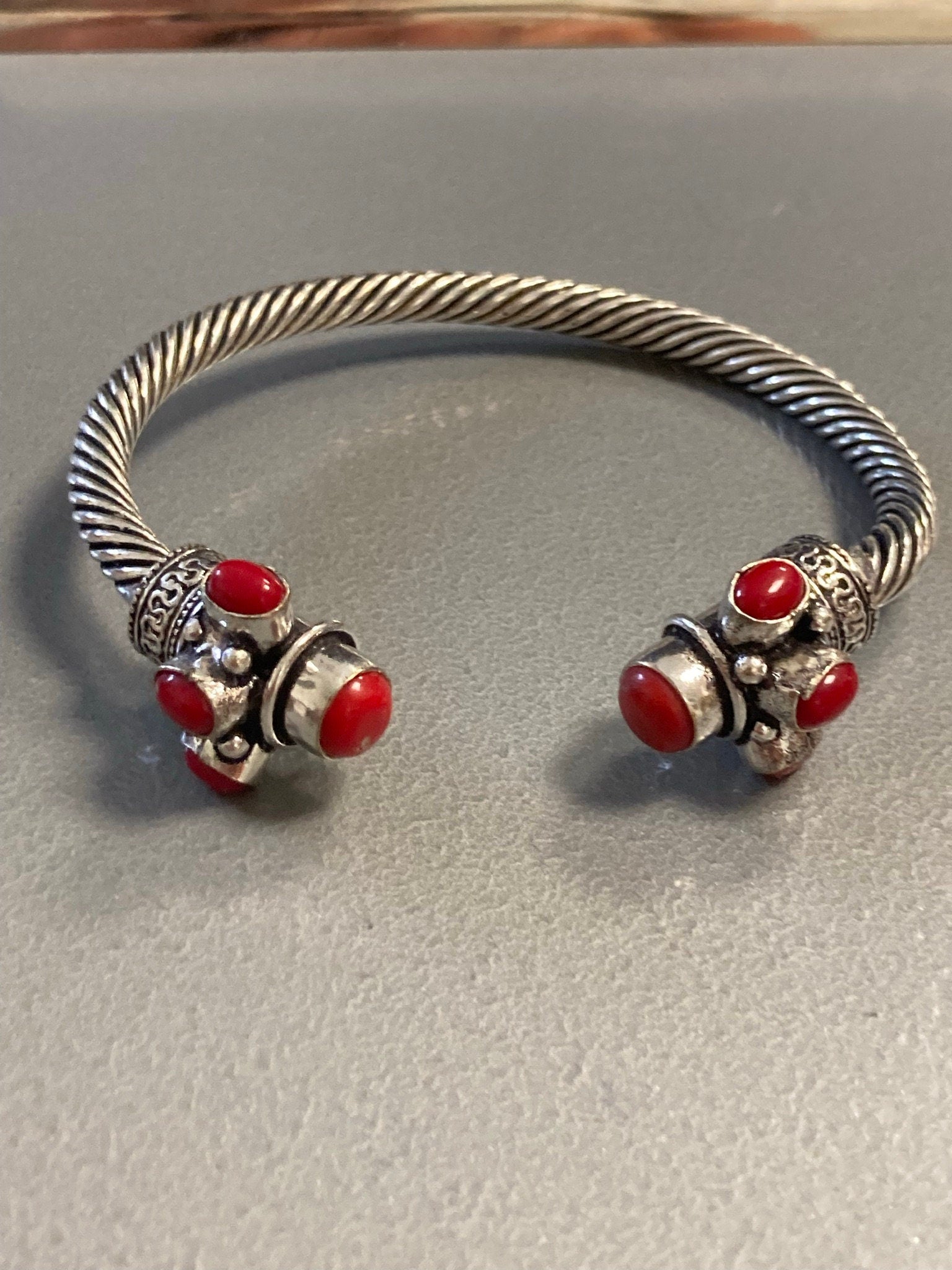 Silver tone torque cuff bangle bracelet with red coral cabochons