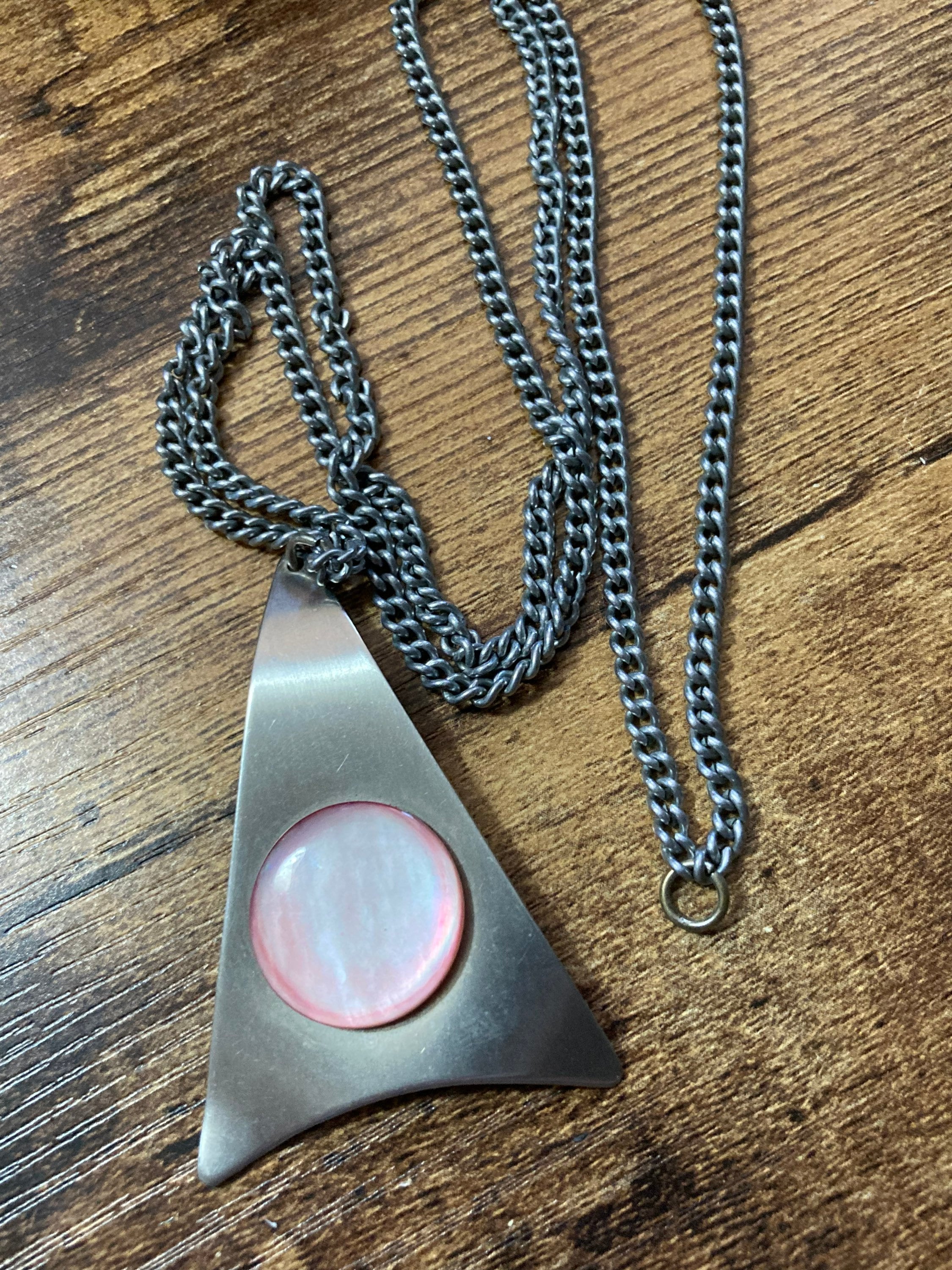 Vintage Modernist stainless steel pendant necklace with central pale pink cabochon