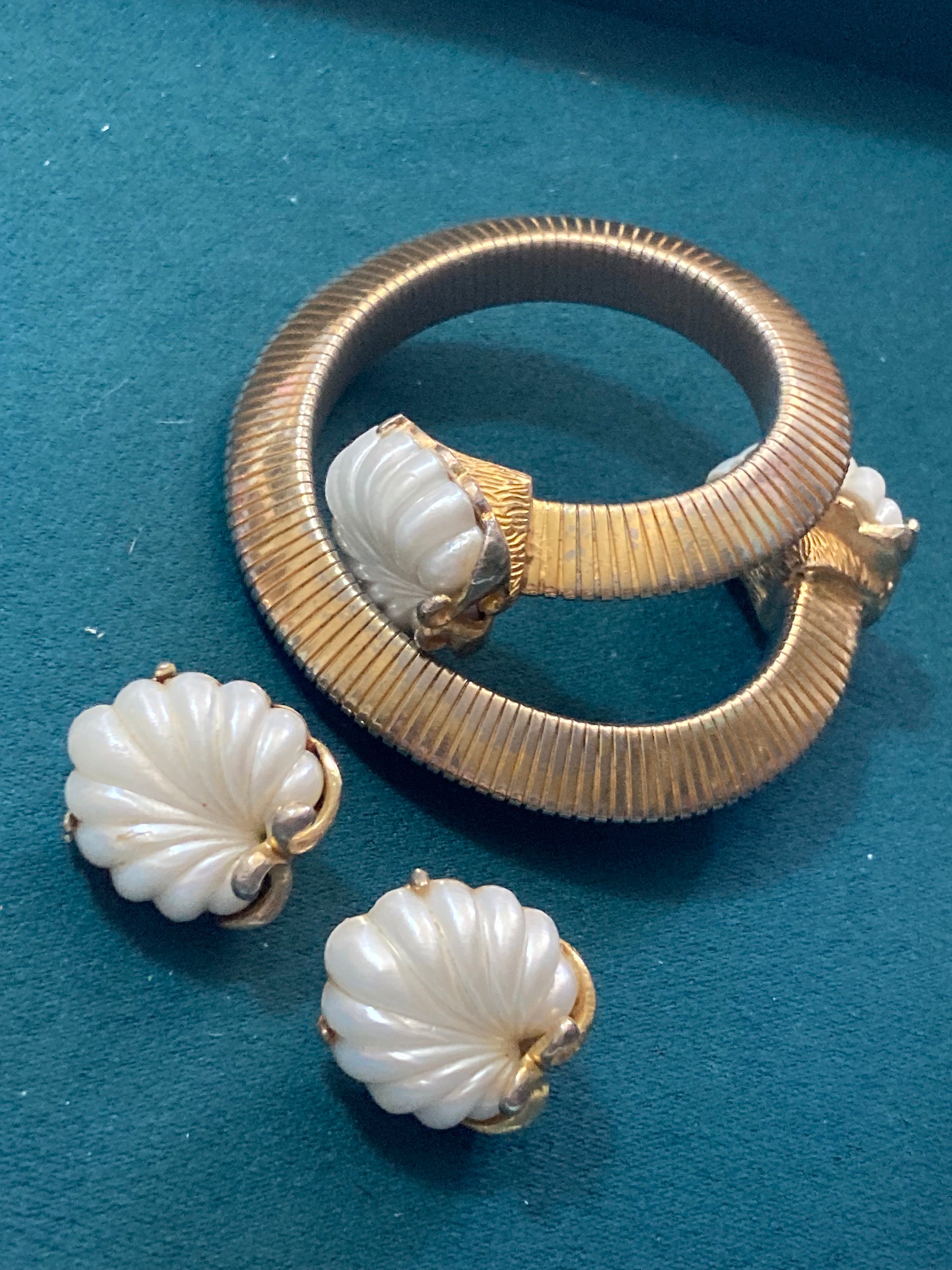 Signed JEWELCRAFT modernist gold tone white lucite shell cabochon omega wrap bangle bracelet and matching clip on earrings jewellery set