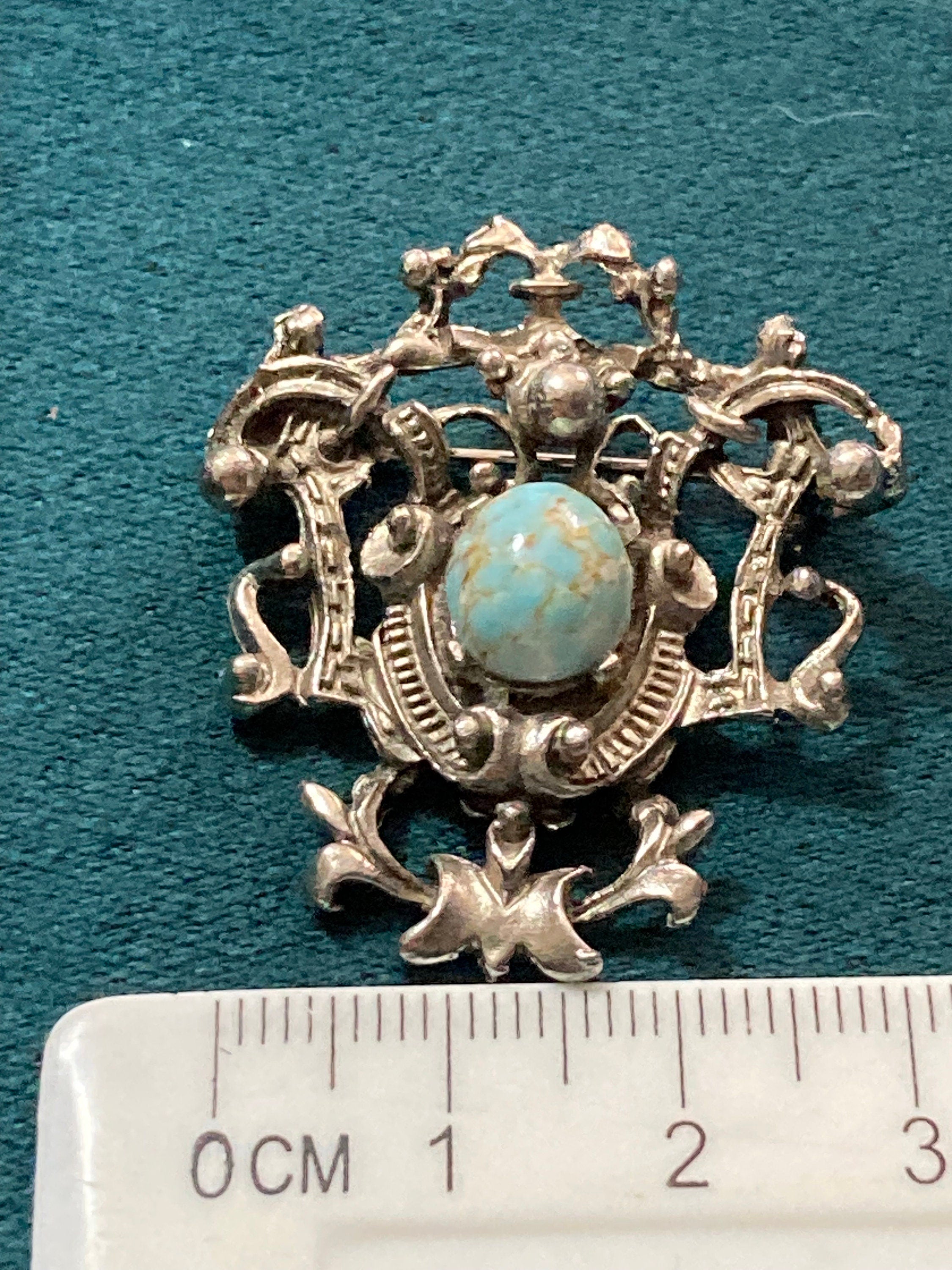 vintage silver tone ornate flirenza style brooch set with turquoise cabochon