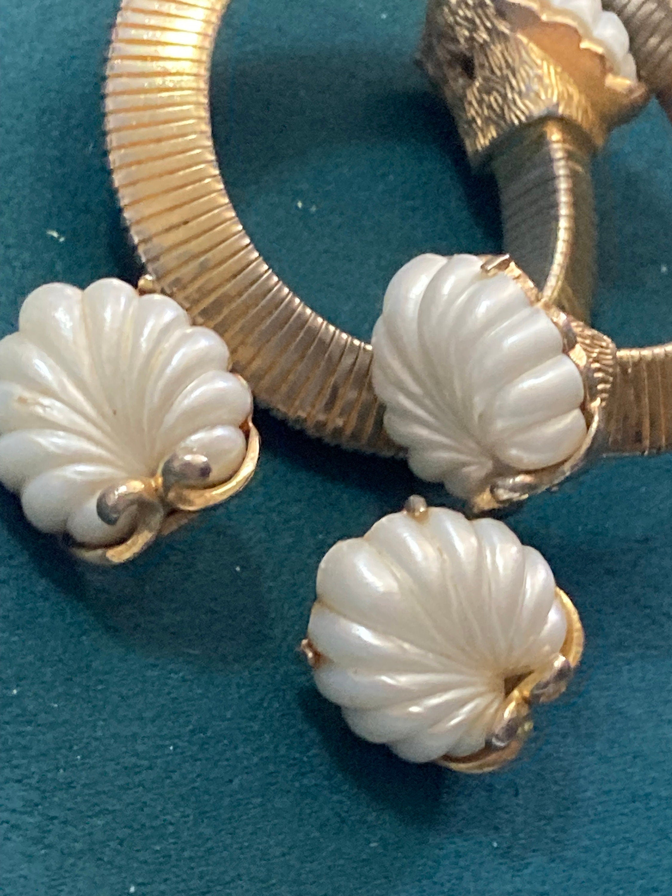 Signed JEWELCRAFT modernist gold tone white lucite shell cabochon omega wrap bangle bracelet and matching clip on earrings jewellery set