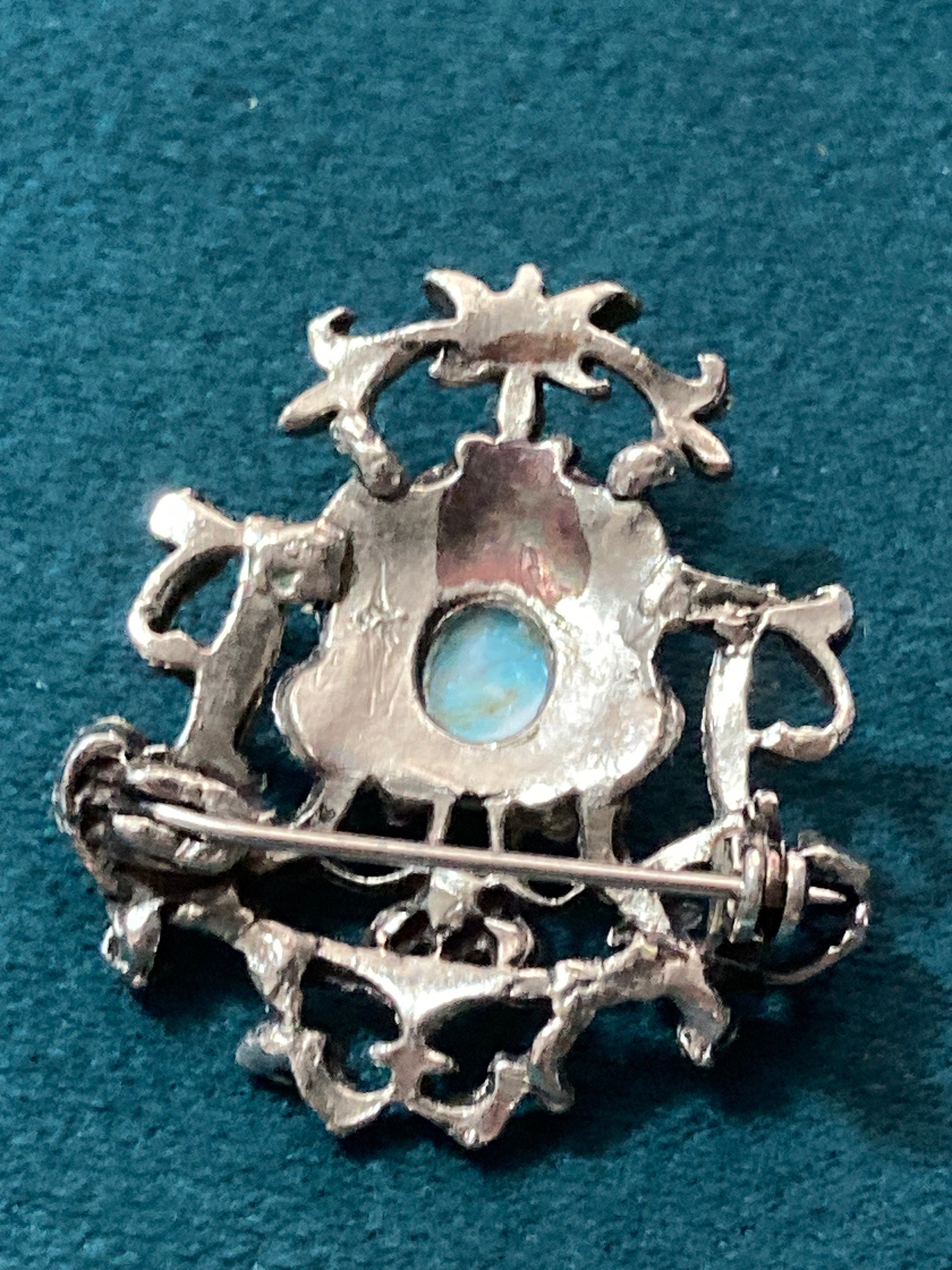 vintage silver tone ornate flirenza style brooch set with turquoise cabochon