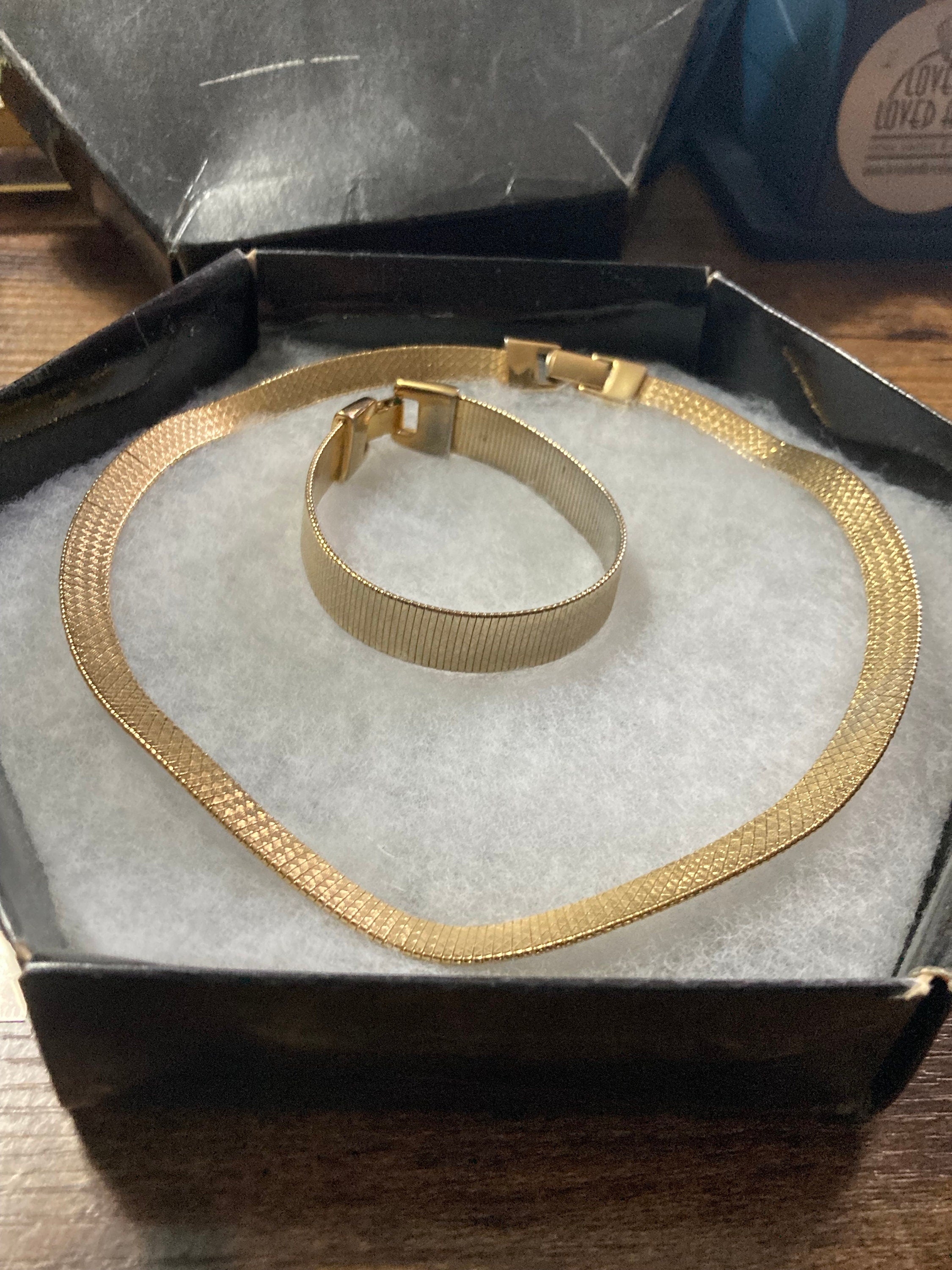 Boxed designer Napier signed matching gold flat mesh necklace and bracelet jewellery set