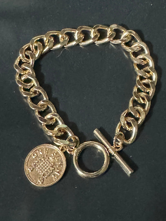 Retro gold tone chain link curb bracelet with faux penny coin charm