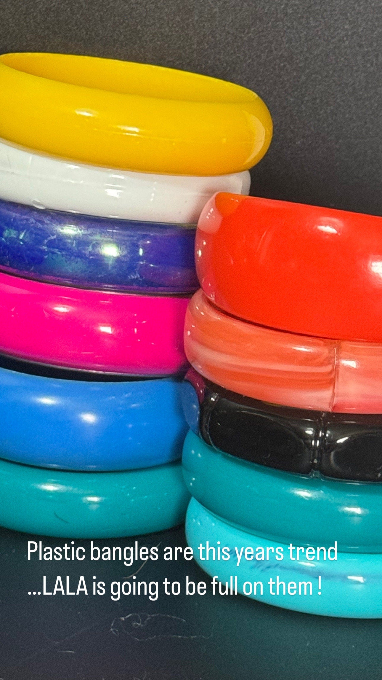 Vintage stack of coloured red purple blue cream pink plastic bangles retro acrylic bracelets