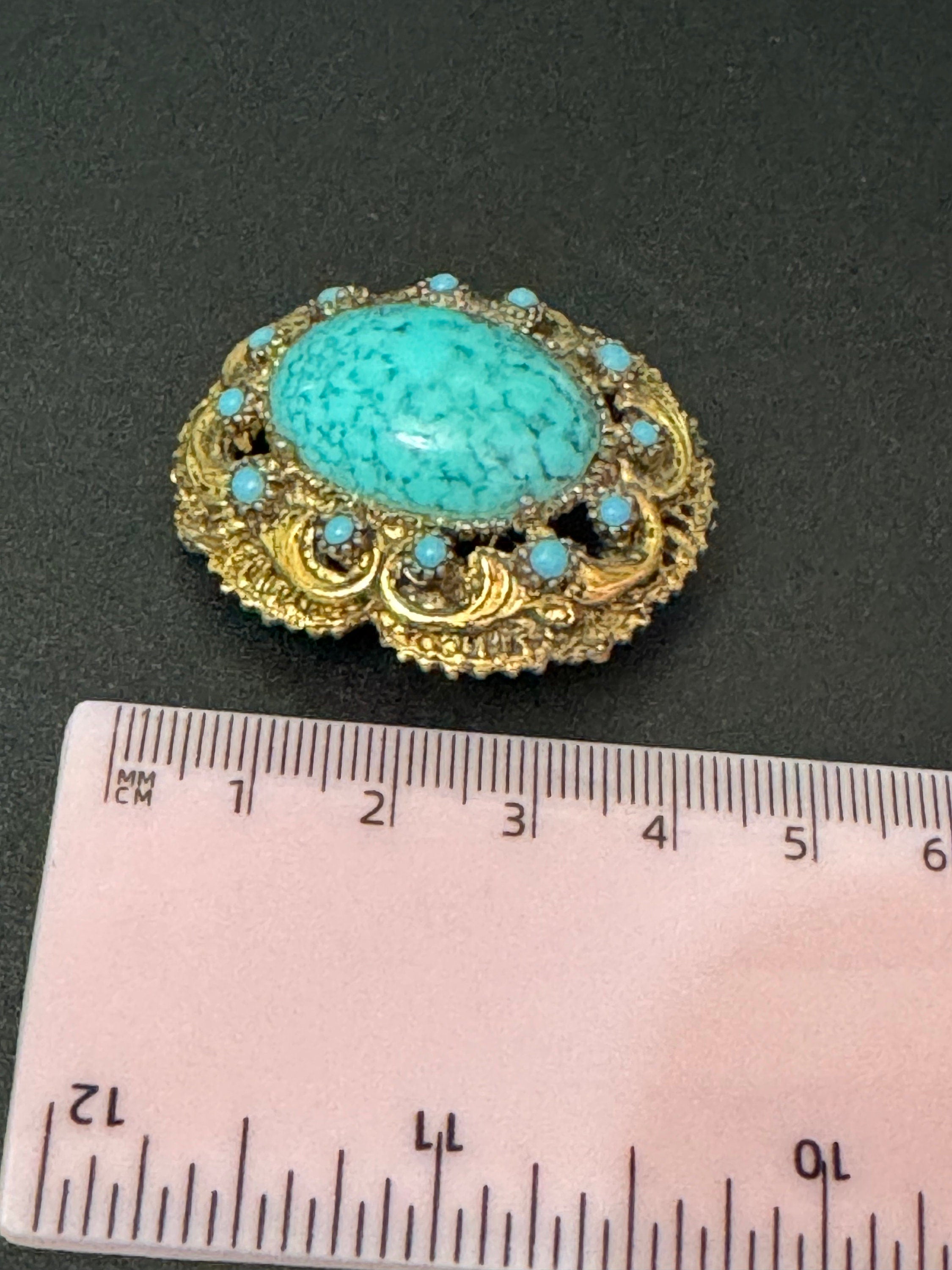 Vintage ornate gold tone turquoise oval cabochon brooch