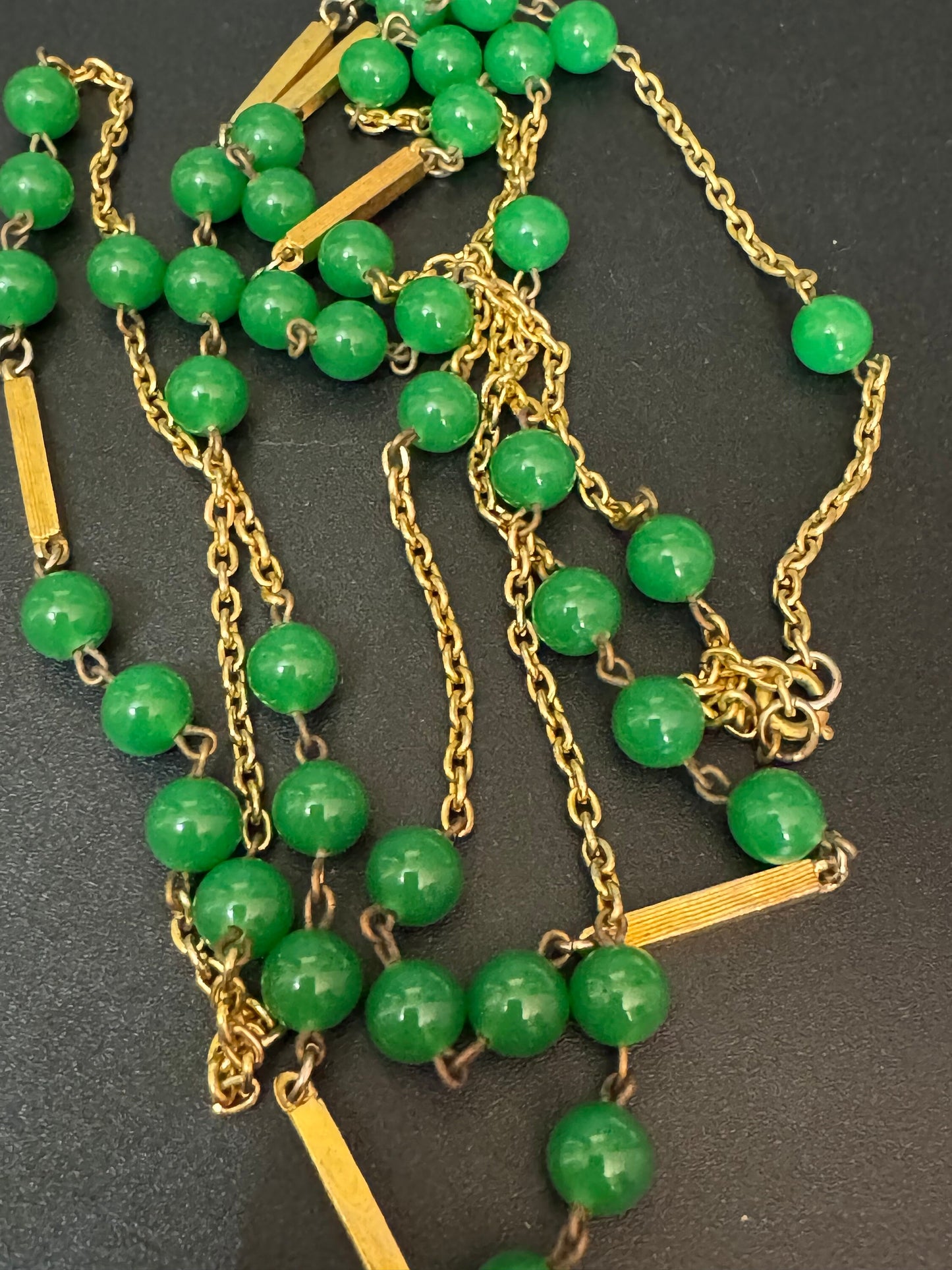 1970s flapper length gold tone metal necklace with bright green jade or glass beads 120cm modernist