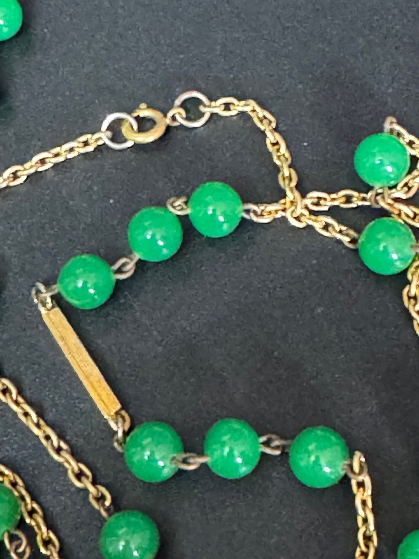 1970s flapper length gold tone metal necklace with bright green jade or glass beads 120cm modernist