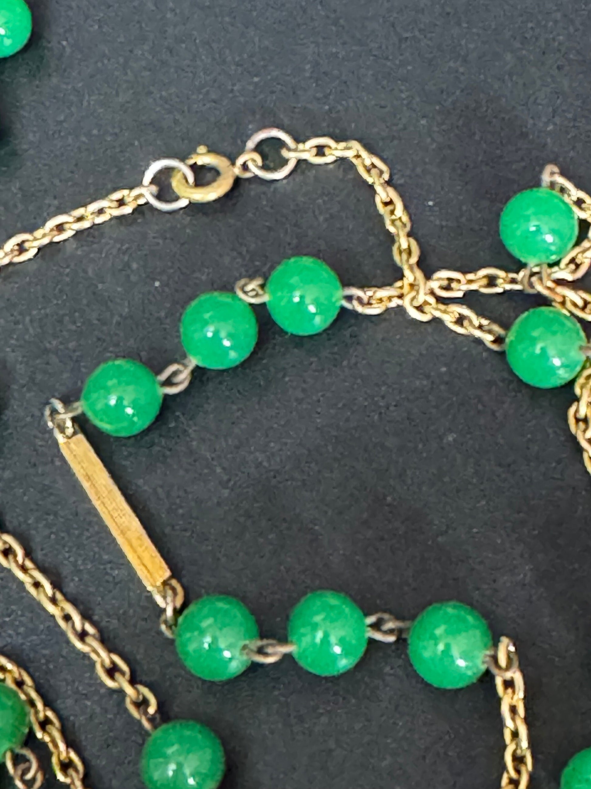 1970s flapper length gold tone metal necklace with bright green jade or glass beads 120cm modernist