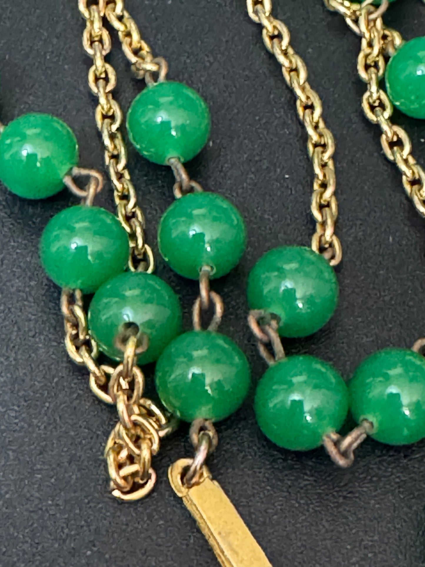 1970s flapper length gold tone metal necklace with bright green jade or glass beads 120cm modernist