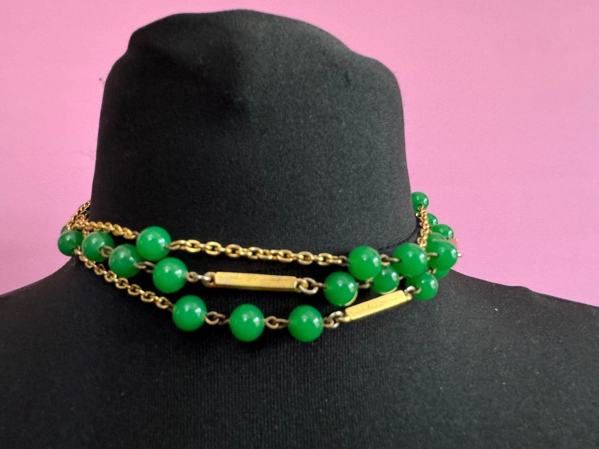 1970s flapper length gold tone metal necklace with bright green jade or glass beads 120cm modernist