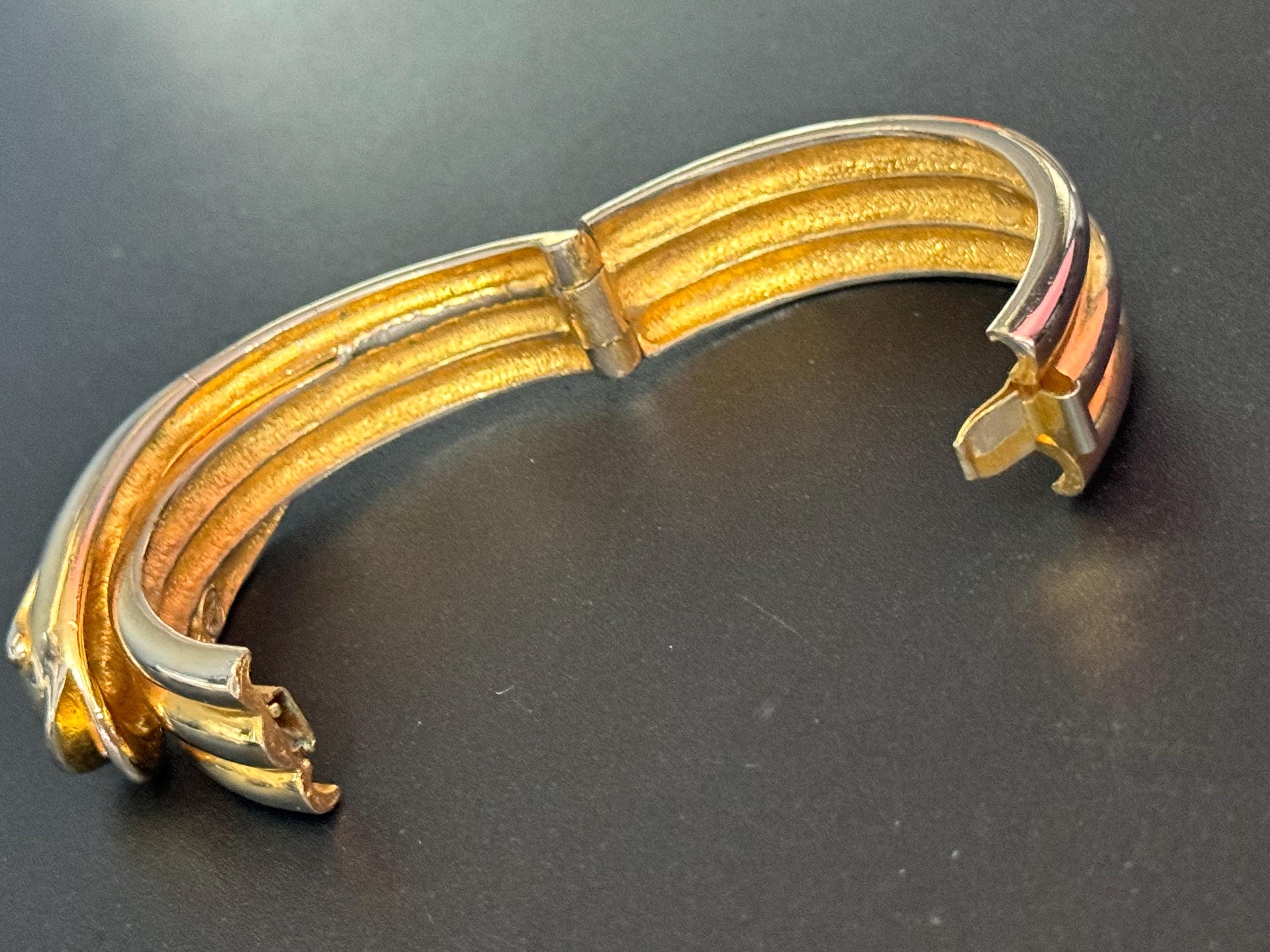 Signed butler and Wilson gold tone snake head clamper bangle cuff bracelet some colour fade