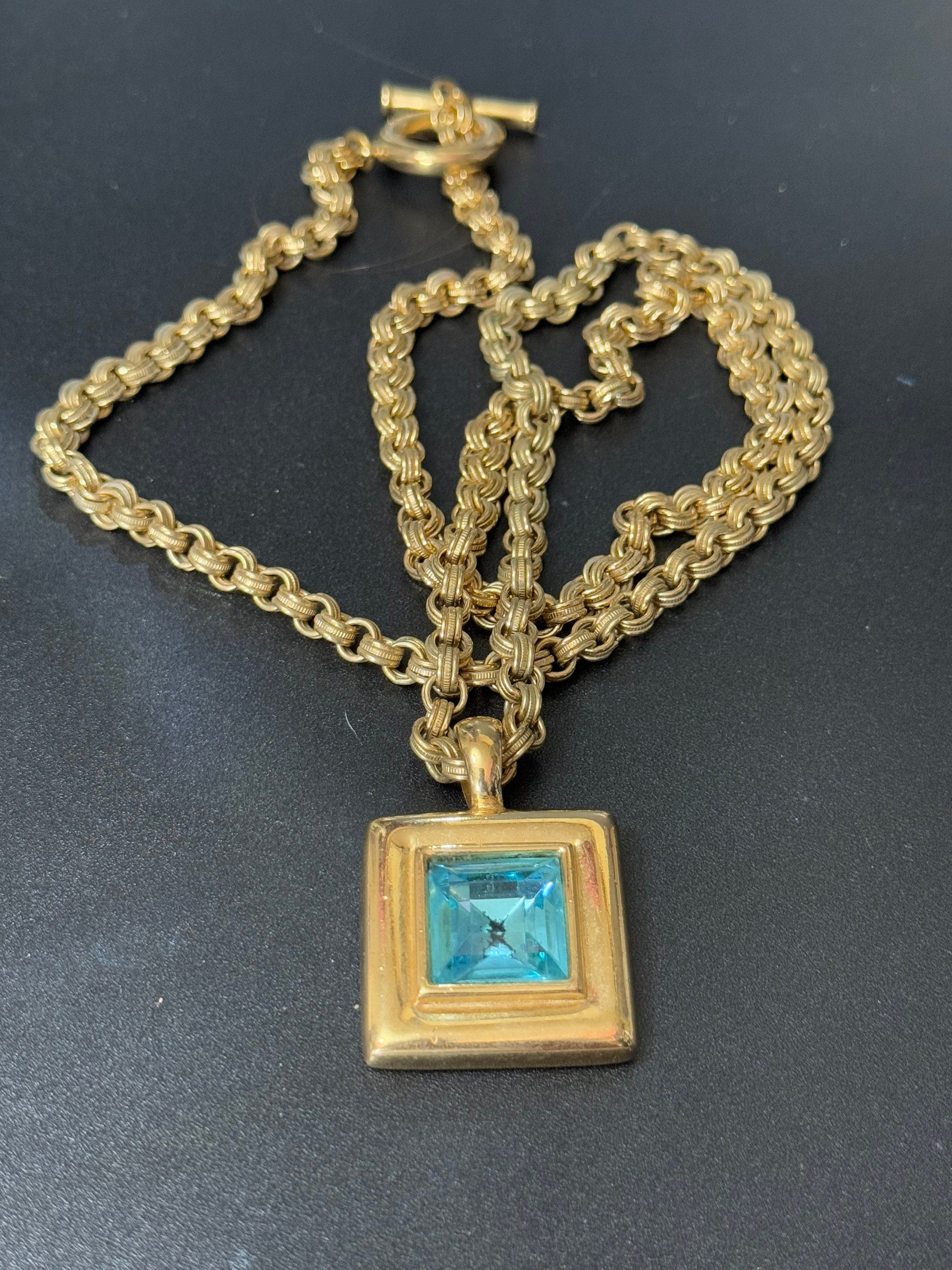 Circa 1980s designer Givenchy Paris New York heavy gold tone square turquoise blue rhinestone pendant necklace on signed 80cm toggle chain