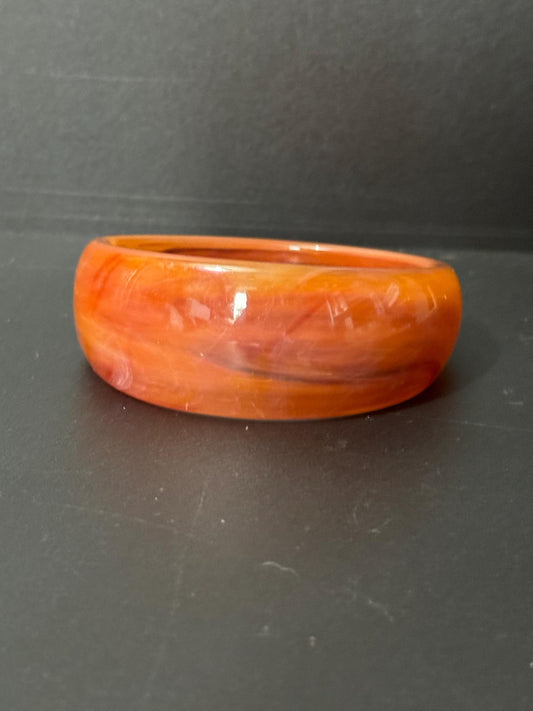 Chunky stack of vintage bangles orange tones early plastic