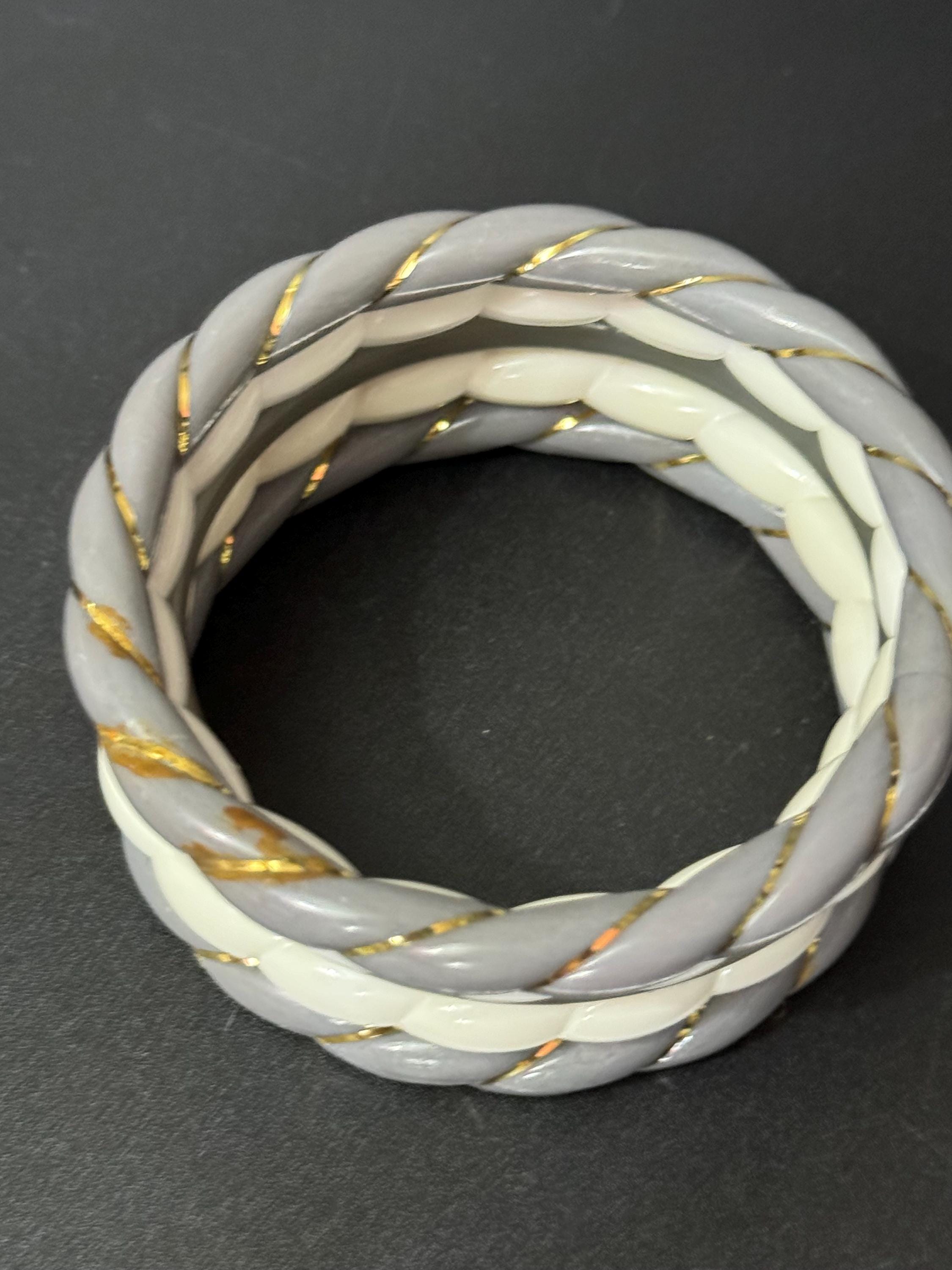 White and grey stack of vintage twisted plastic bangles