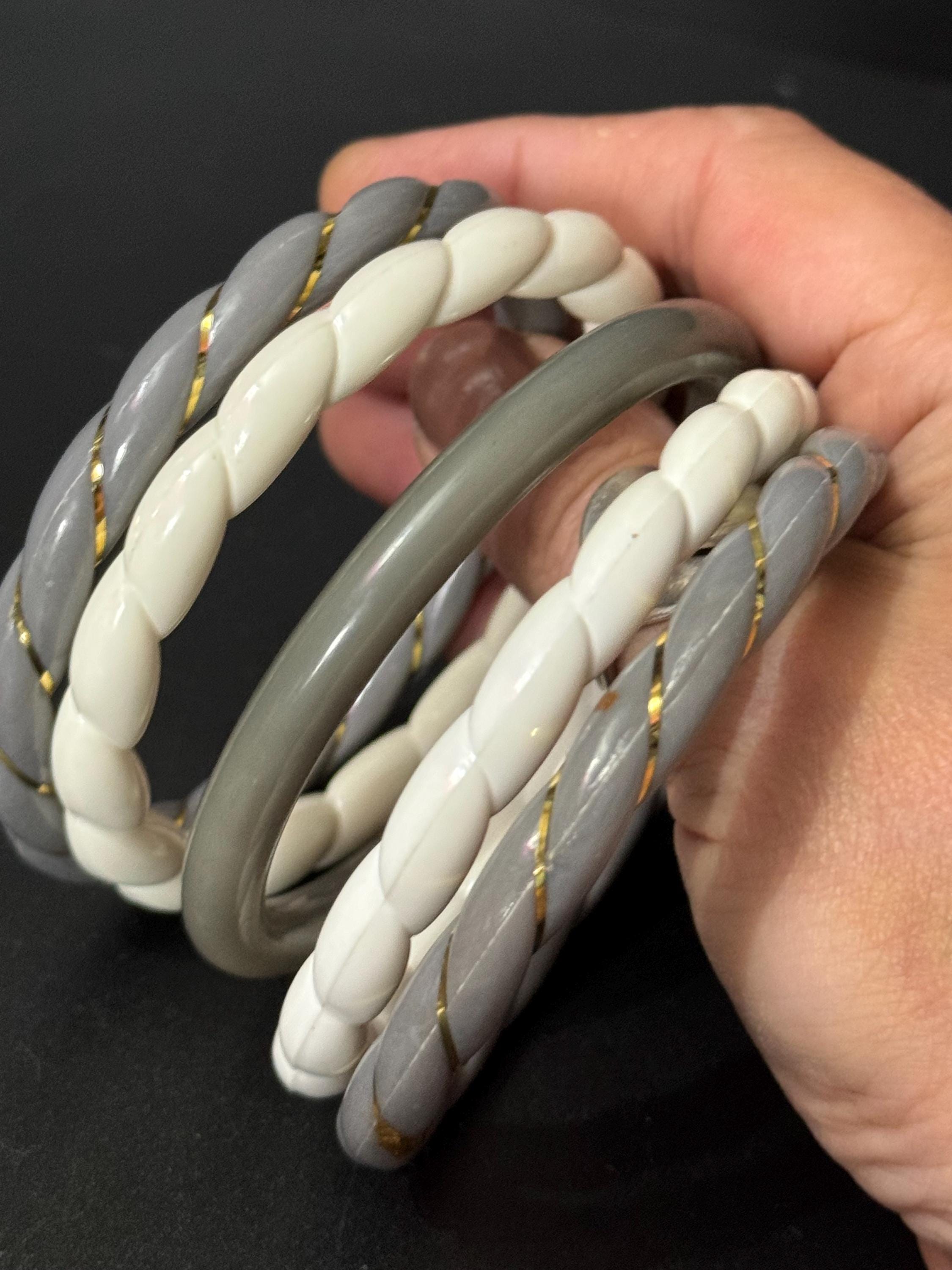 White and grey stack of vintage twisted plastic bangles