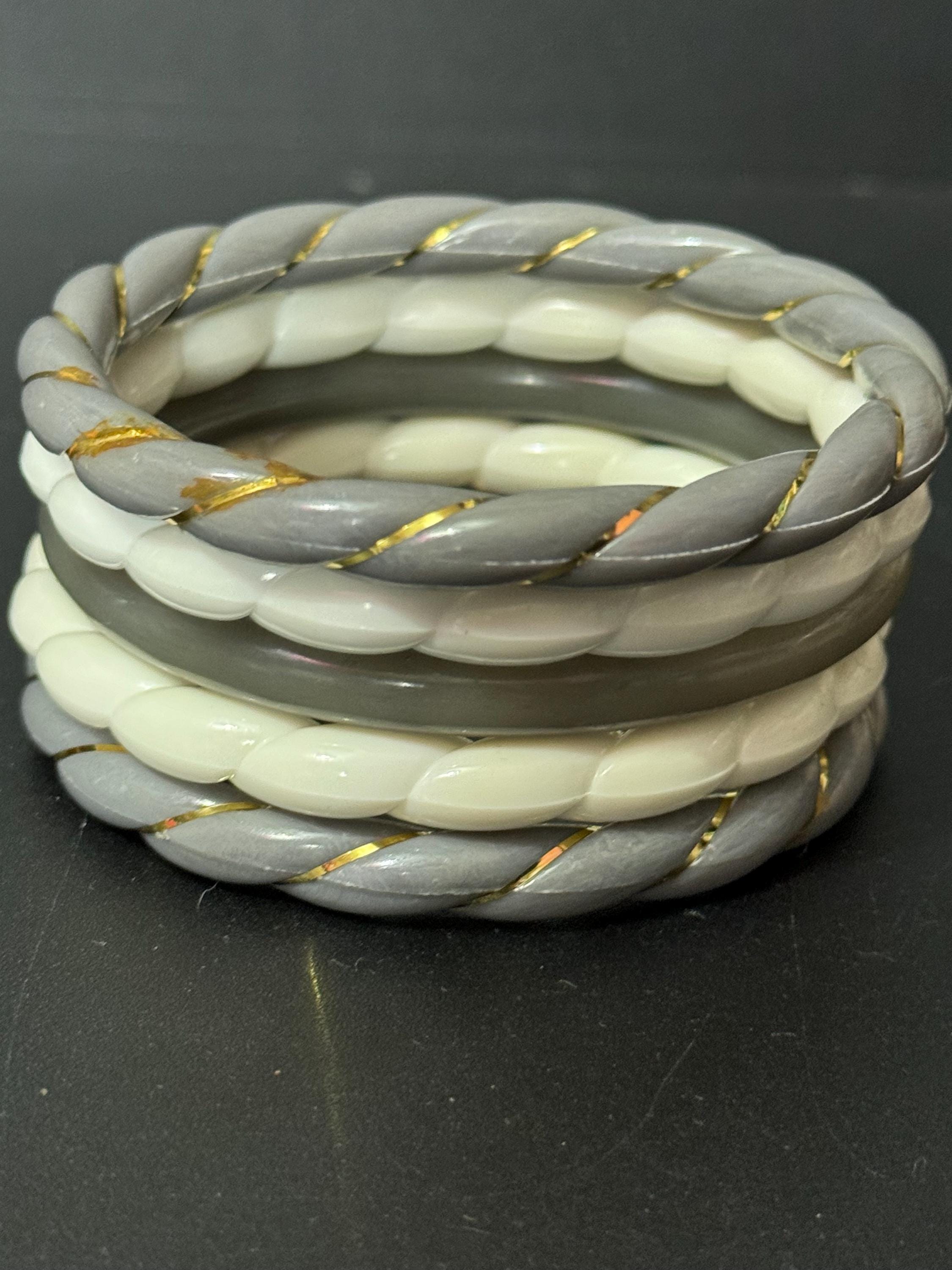 White and grey stack of vintage twisted plastic bangles