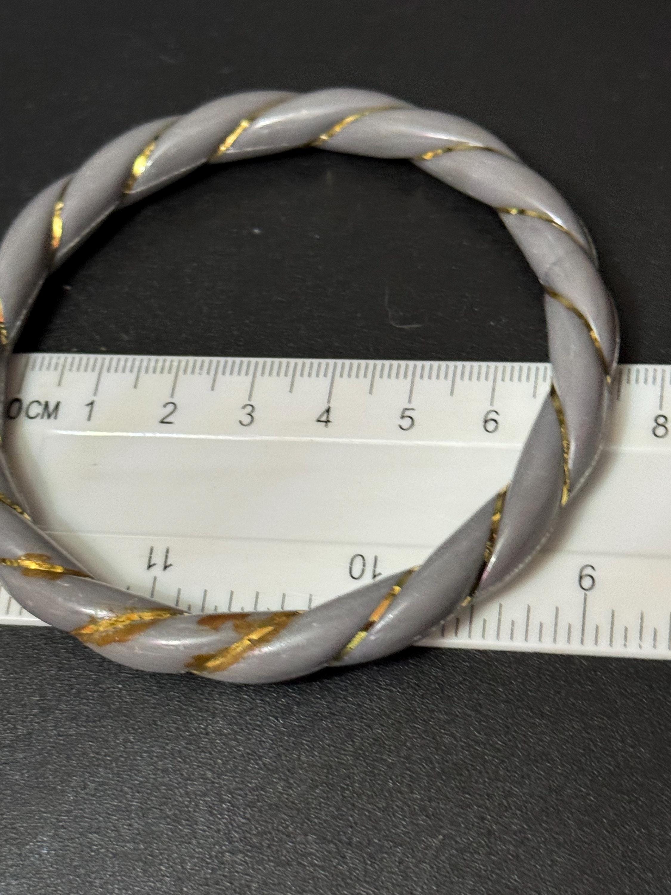 White and grey stack of vintage twisted plastic bangles