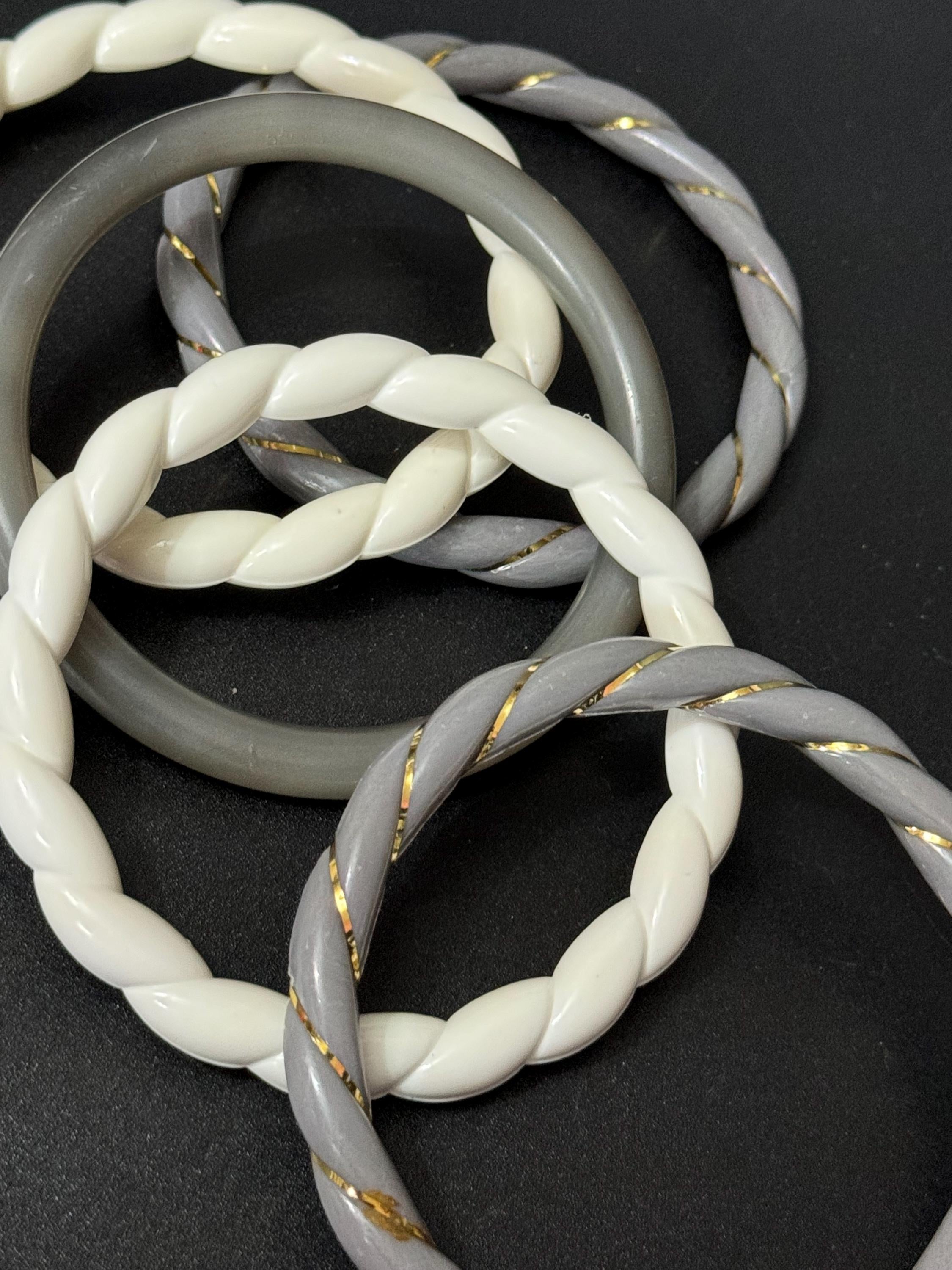 White and grey stack of vintage twisted plastic bangles