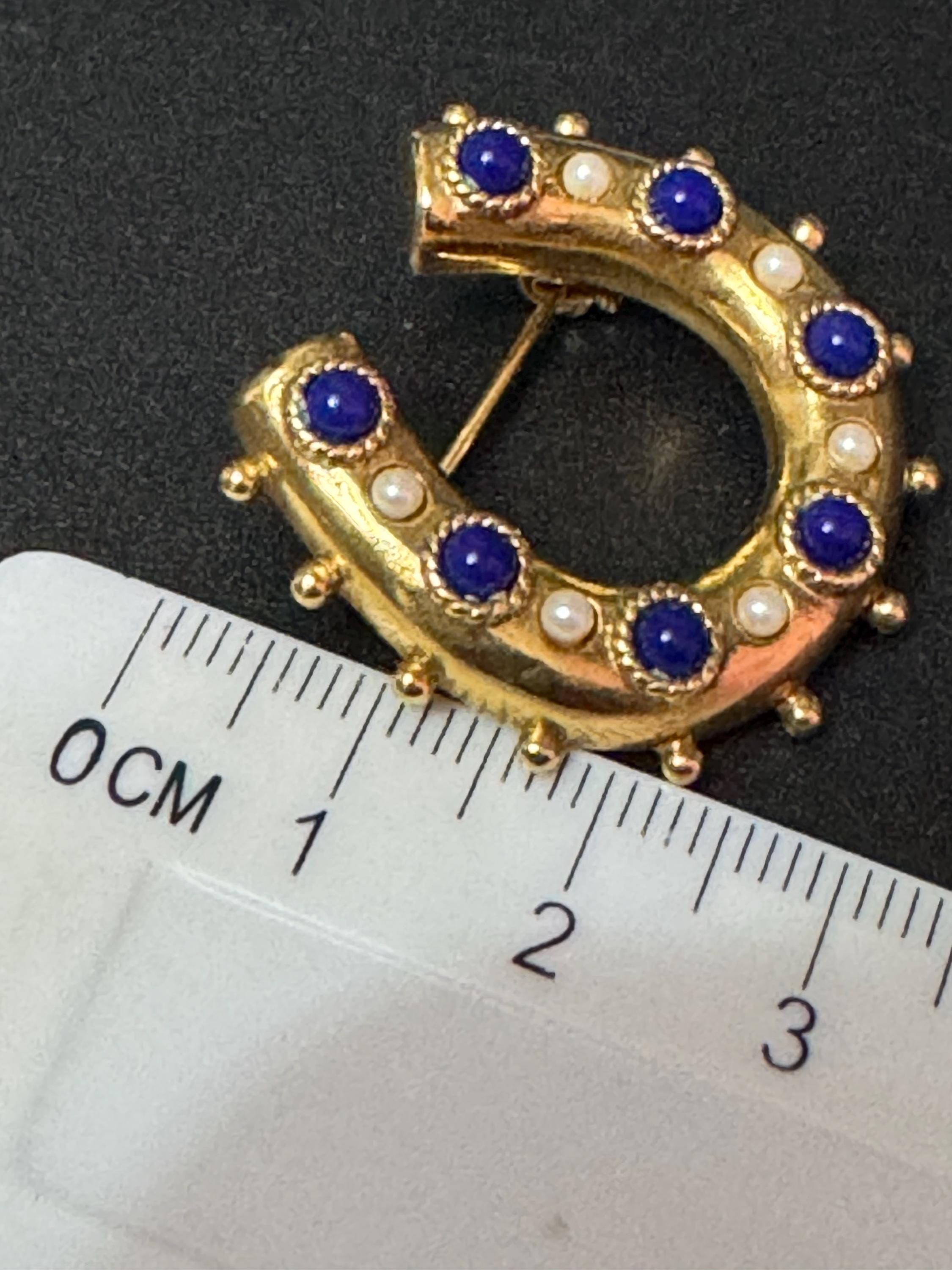 Victorian style gold plated horseshoe brooch with seed pearls and blue gemstones roll clasp