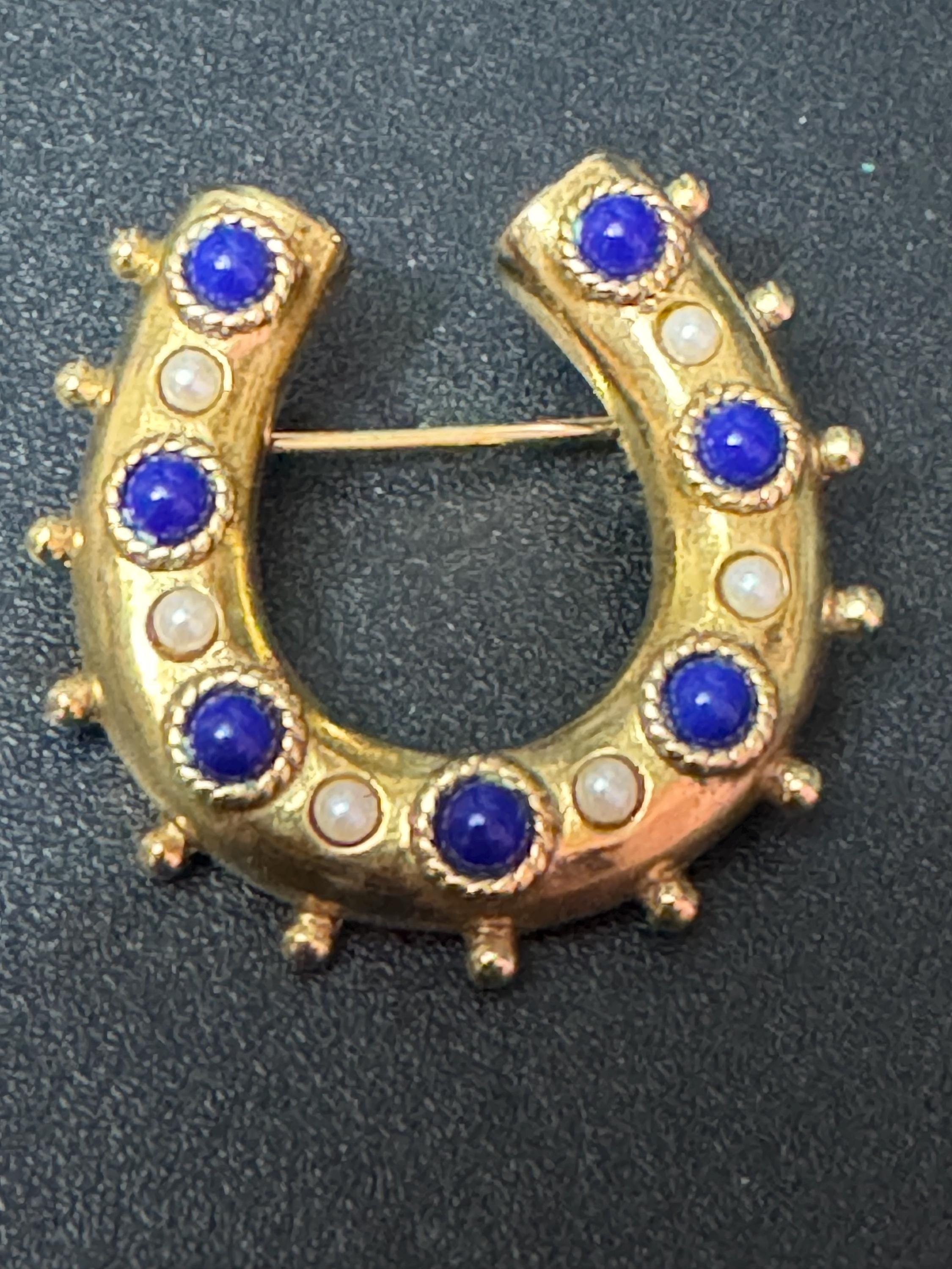 Victorian style gold plated horseshoe brooch with seed pearls and blue gemstones roll clasp