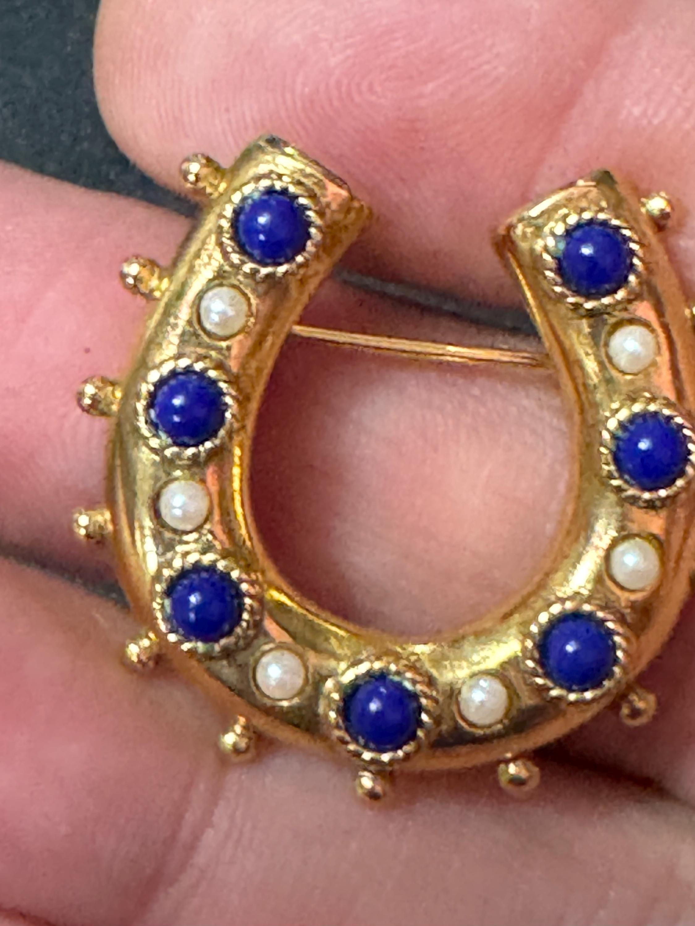 Victorian style gold plated horseshoe brooch with seed pearls and blue gemstones roll clasp