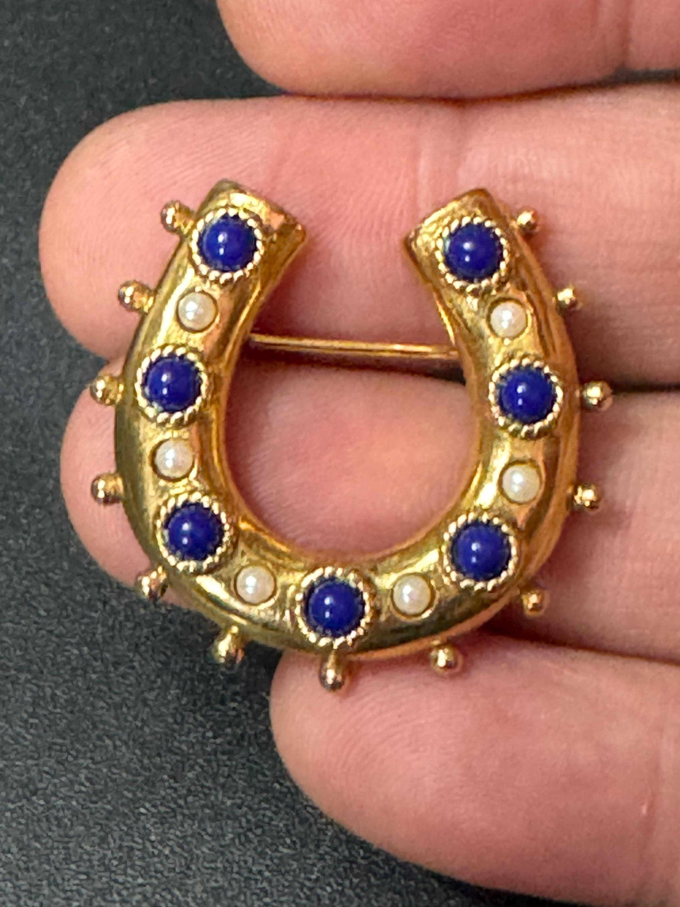 Victorian style gold plated horseshoe brooch with seed pearls and blue gemstones roll clasp