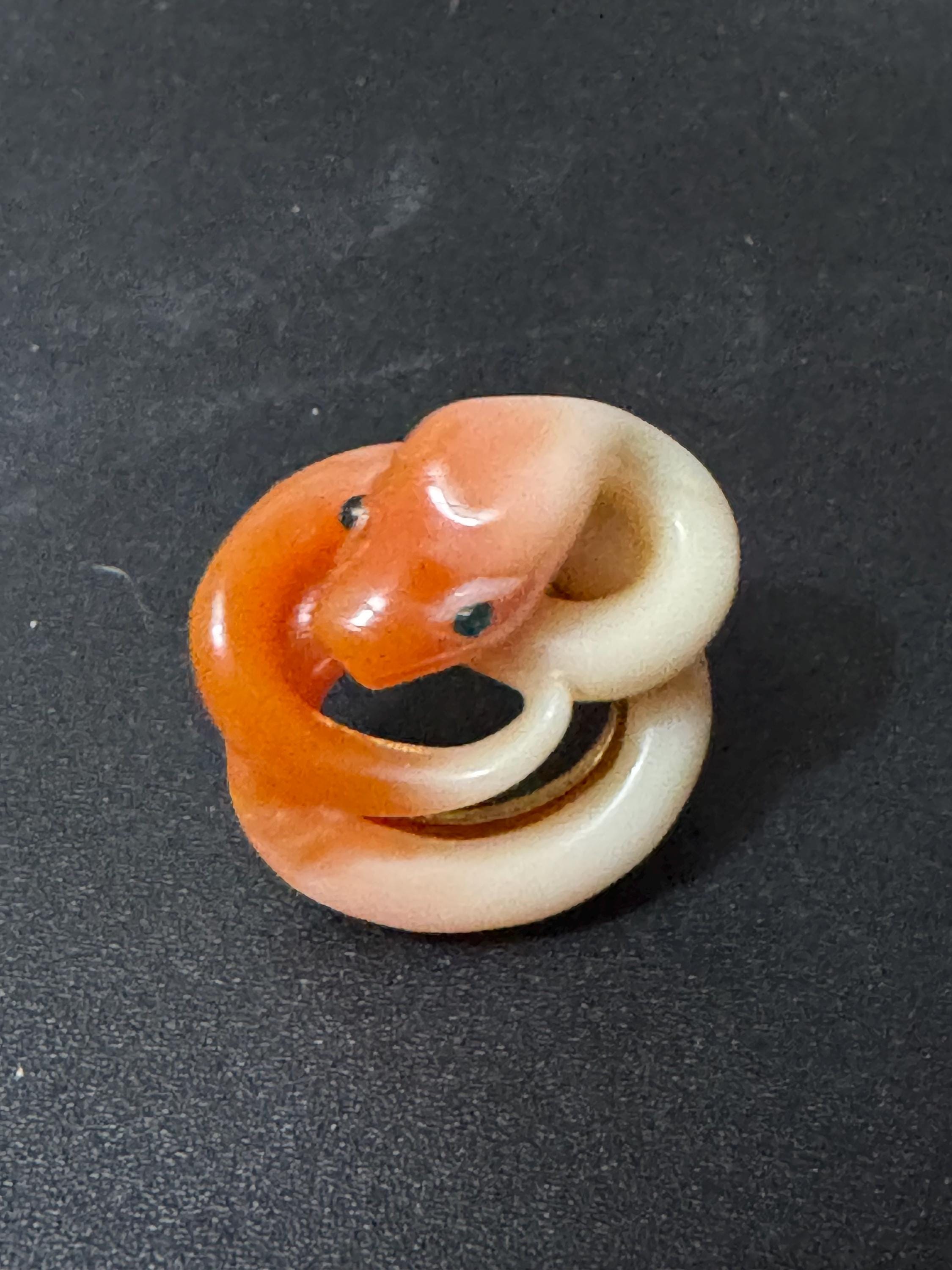 Vintage gold tone orange plastic curled snake ring with emerald eyes adjustable